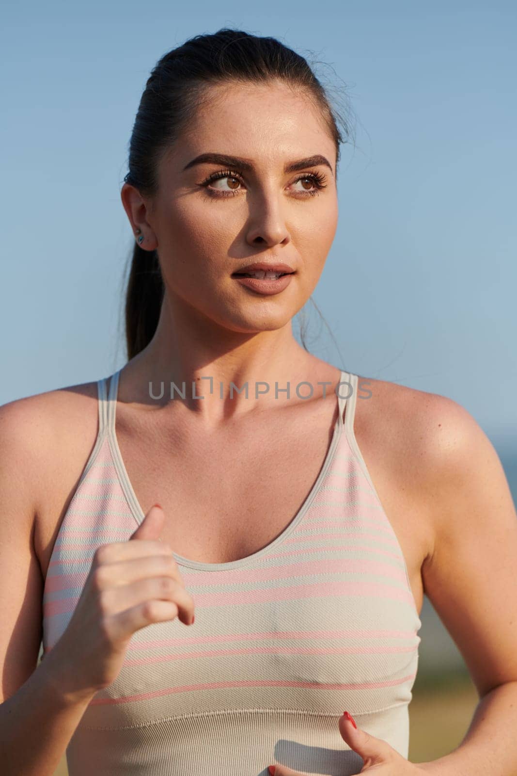 Focused Stride: Close-Up Capture of Intensely Running Athlete. by dotshock