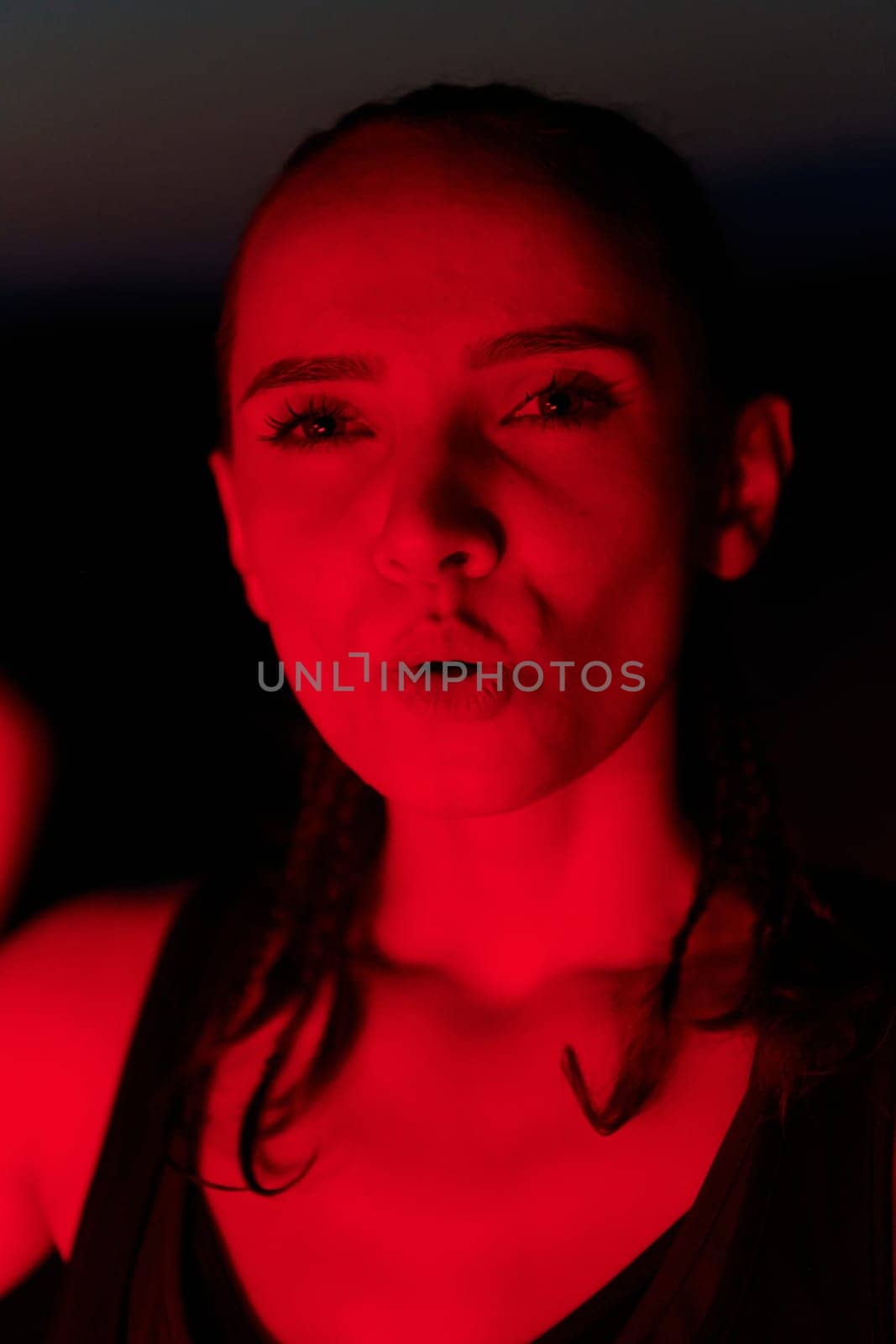 Athlete Strikes a Pose in Red-Lit Nighttime Glow by dotshock