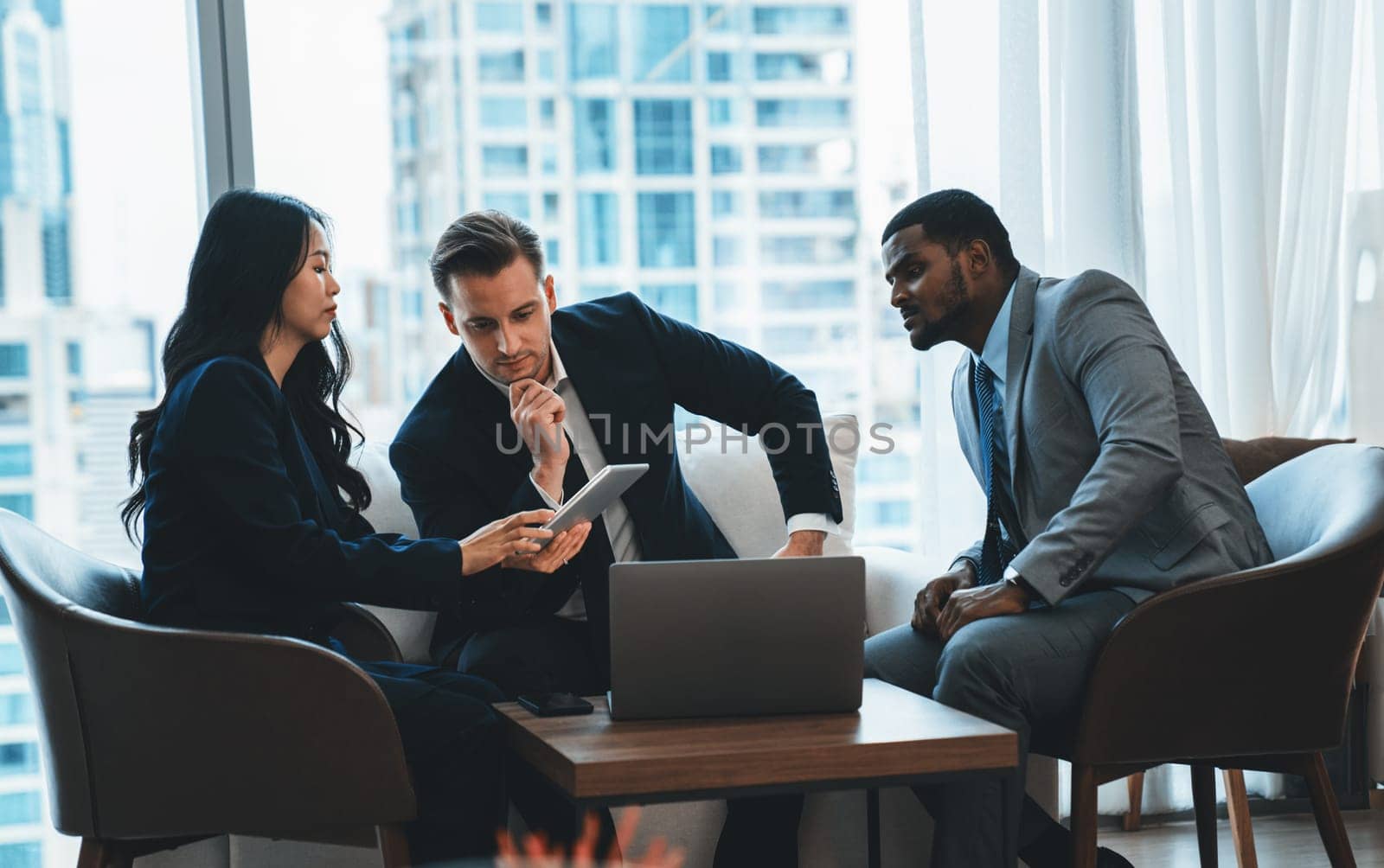 Young smart businesswoman showing data analysis to diverse investor by using tablet. Multicultural business group discussing and investing in start up project. Modern office. Meeting. Ornamented.