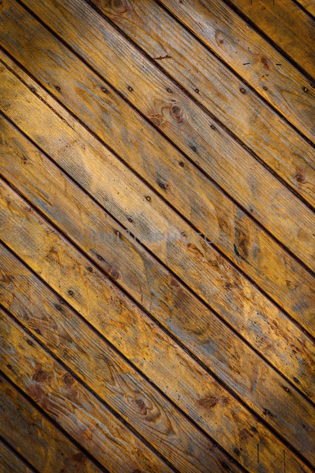 Wooden wall made of diagonal boards with light brown stripes. Background.2 by Mixa74