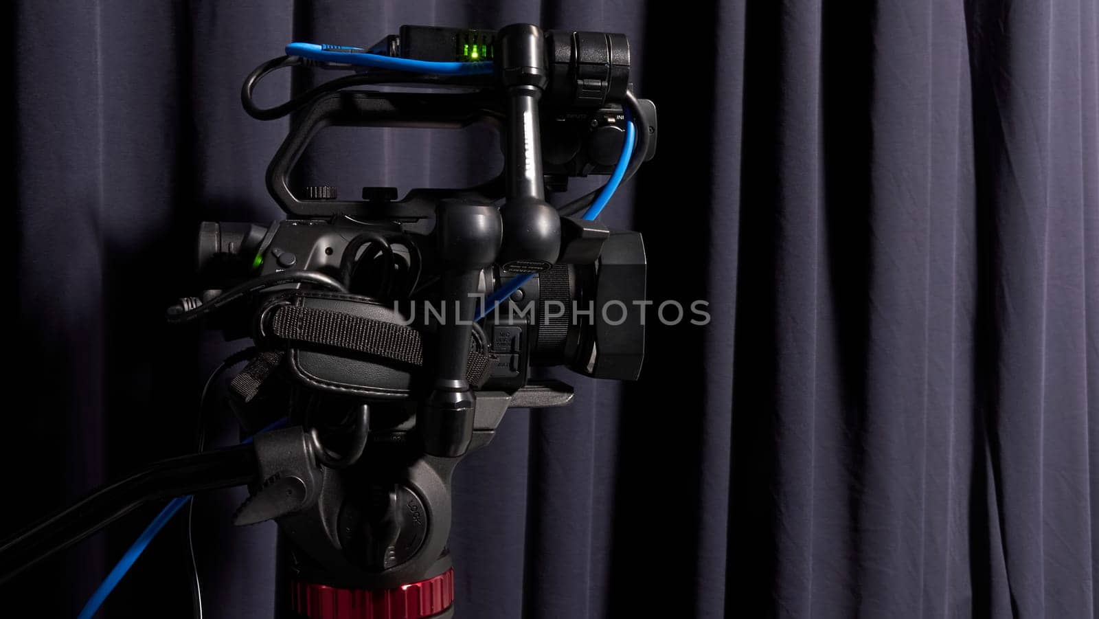 The image of video camera under the tripod