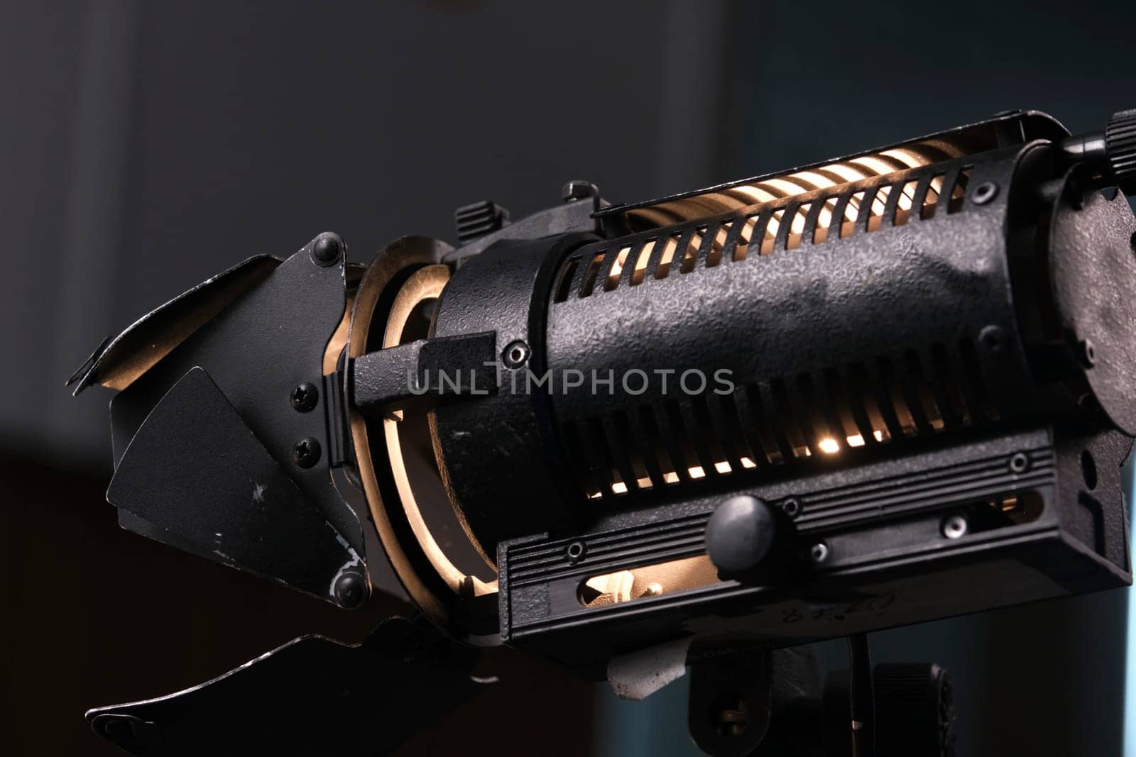 Close-up of a professional lighting fixture on a set or photographic studio. Concept of shooting a movie. by lempro