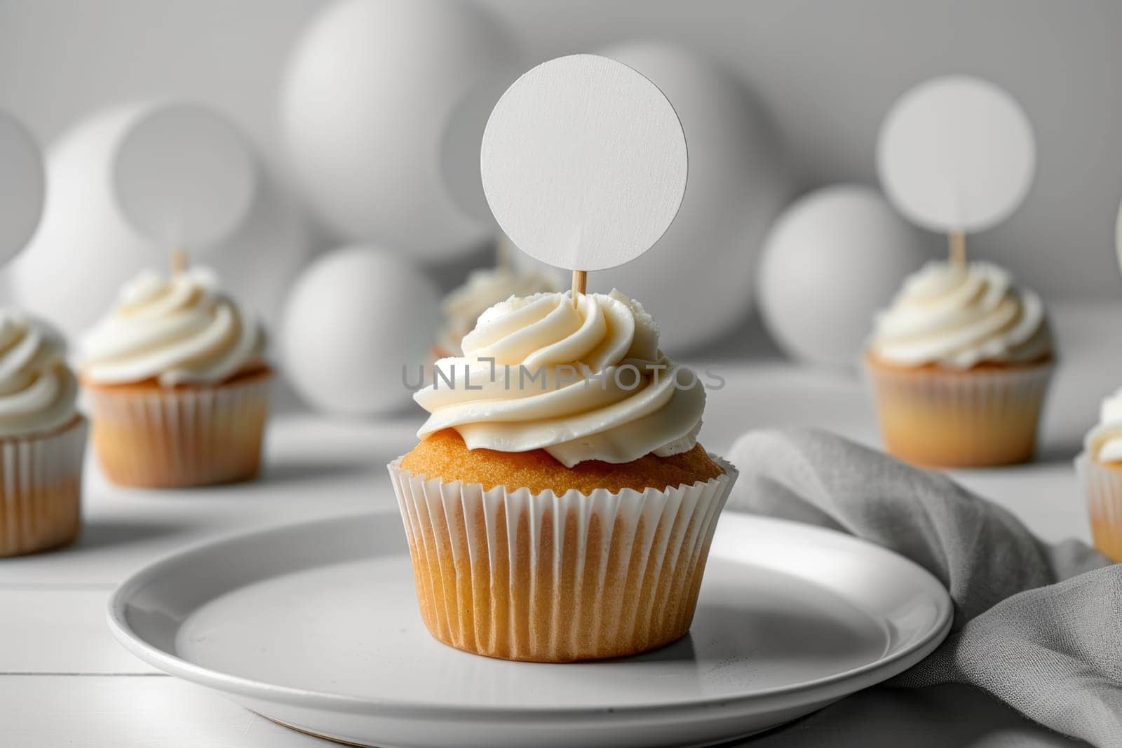 Cupcake with white cream and an inscription plate on a white background.