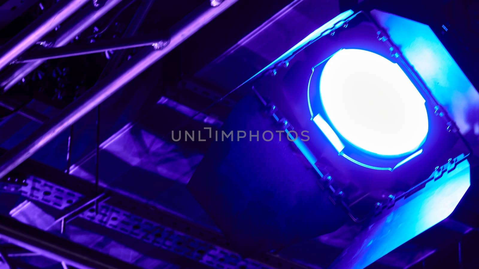 Close-up of a professional lighting fixture on a set or photographic studio. Concept of shooting a movie. by lempro