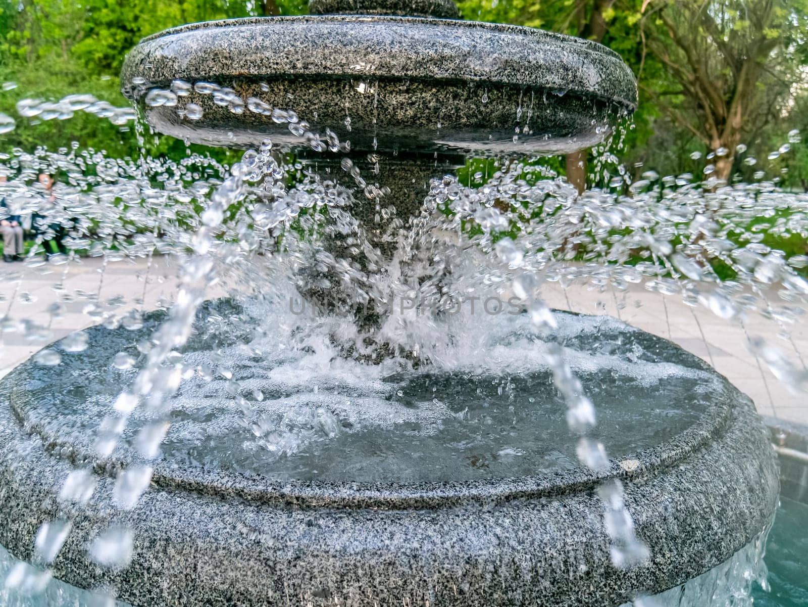 Round fountain in the city park in summer day by lempro