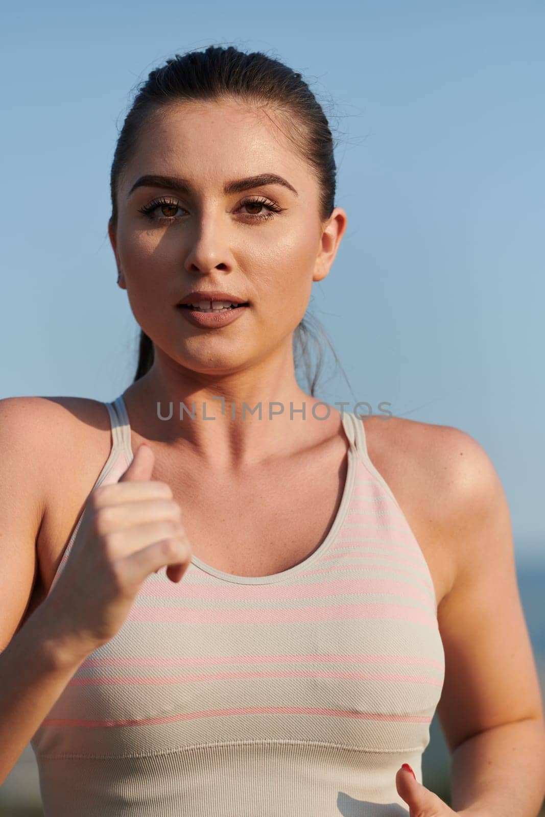 Focused Stride: Close-Up Capture of Intensely Running Athlete. by dotshock