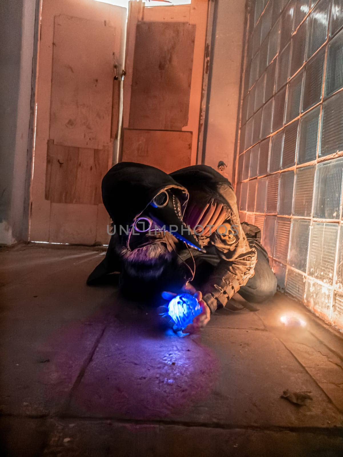 Cosplay of a stalker lying on the floor of an abandoned house in a plague doctor mask and holding a mysterious artifact. art photography by lempro