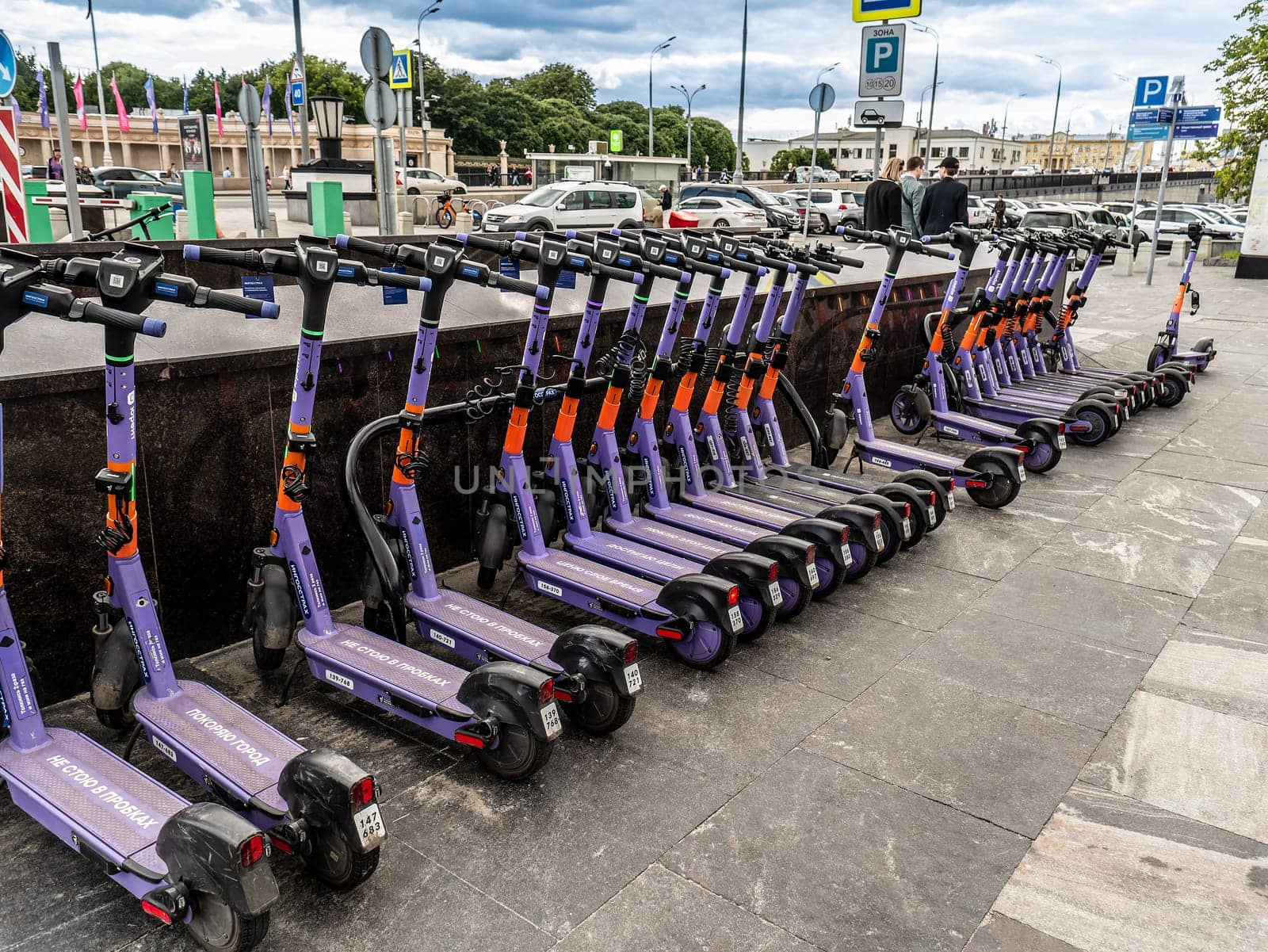 Parking for electric scooters on the square next to Gorky Park City electric scooter rental - kick sharing. Scooters standing in a special city parking lot. Moscow Russia 2023