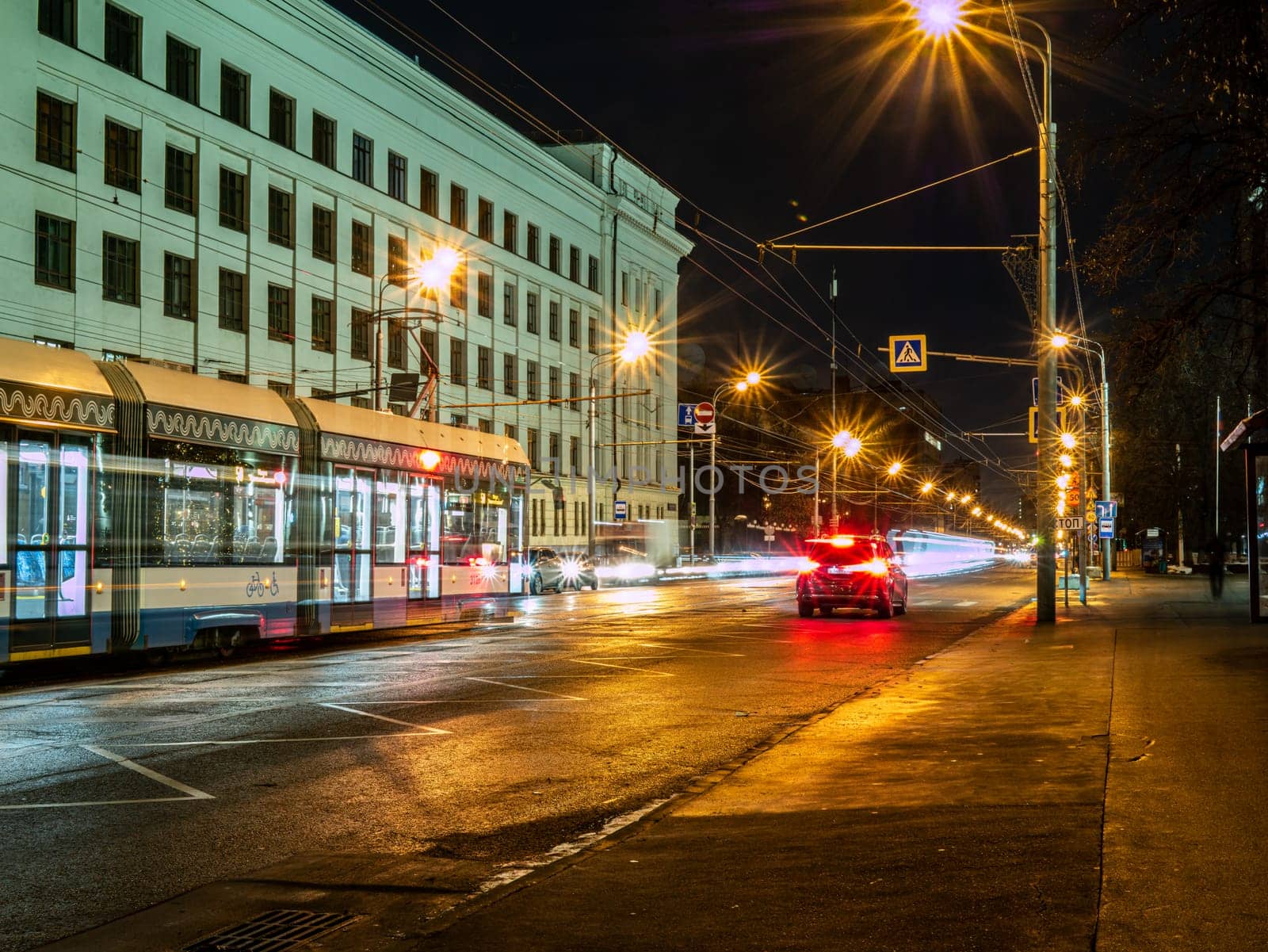 long exposure tram in a blurry form in the night city center , Moscow, Russia. low light shoot by lempro