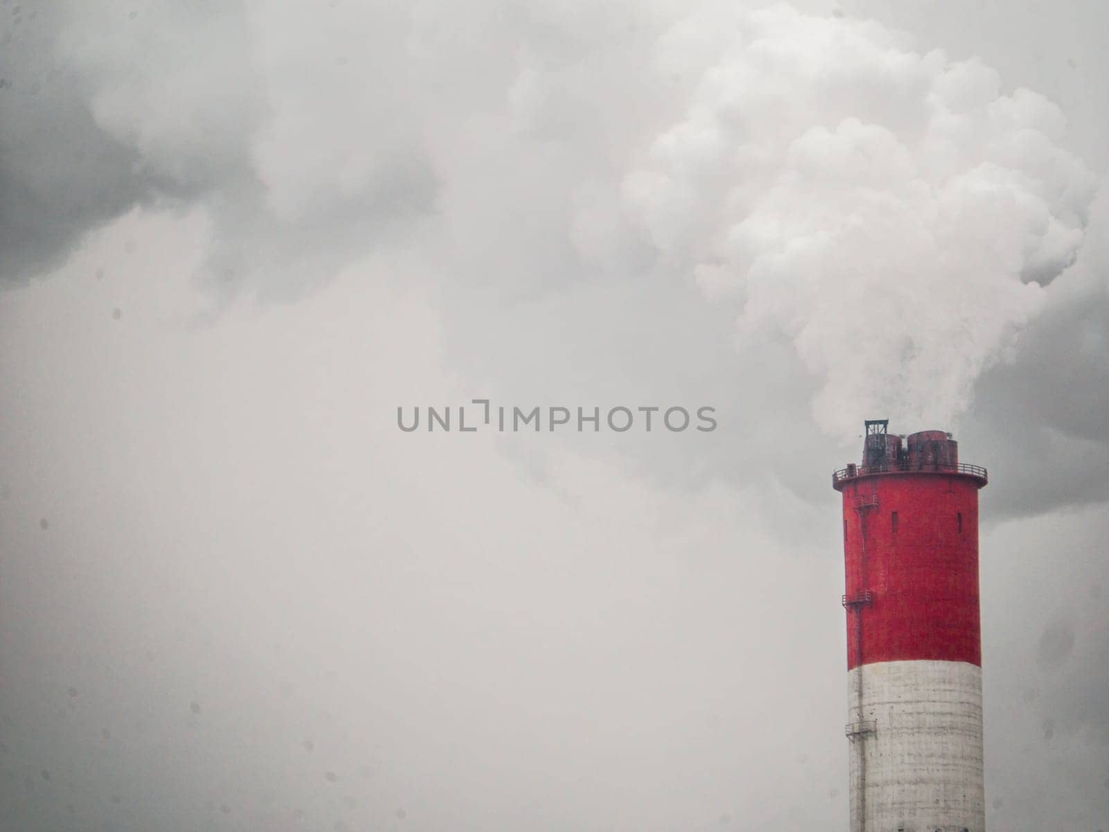 smoke coming out of a large factory chimney. Close-up of smoke coming out of chimneys against the sky. Air pollution concept. color nature by lempro