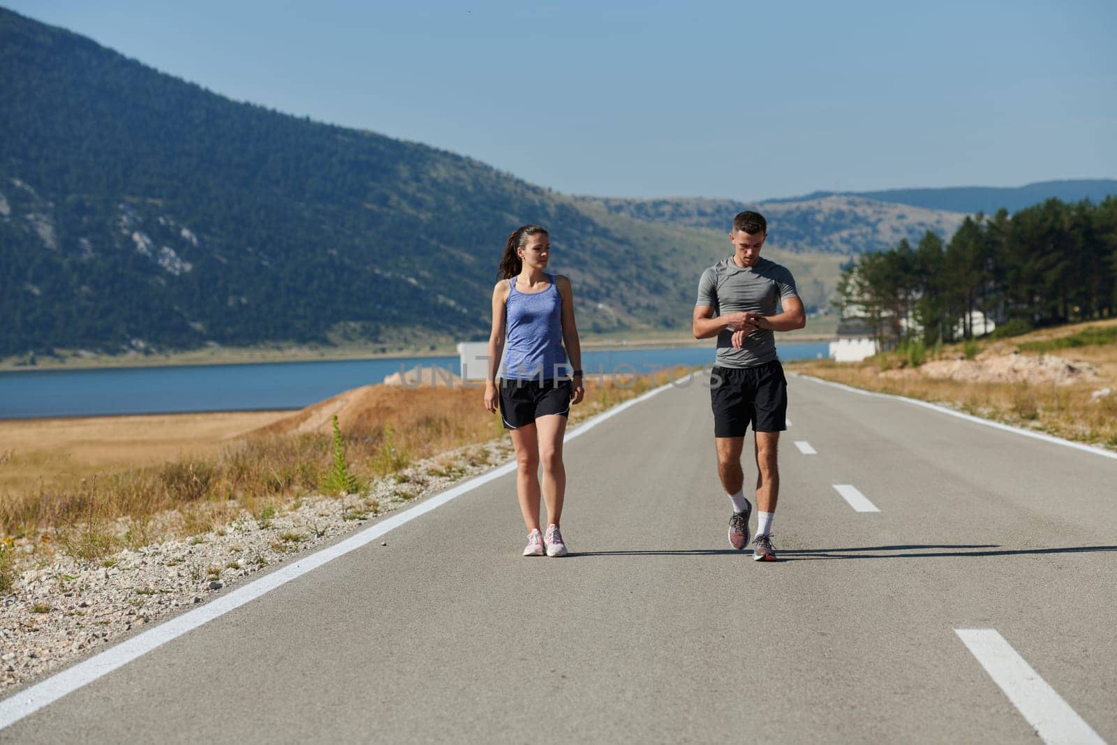 After-Run Relaxation: Romantic Couple Rests Following Intense Training Session. by dotshock