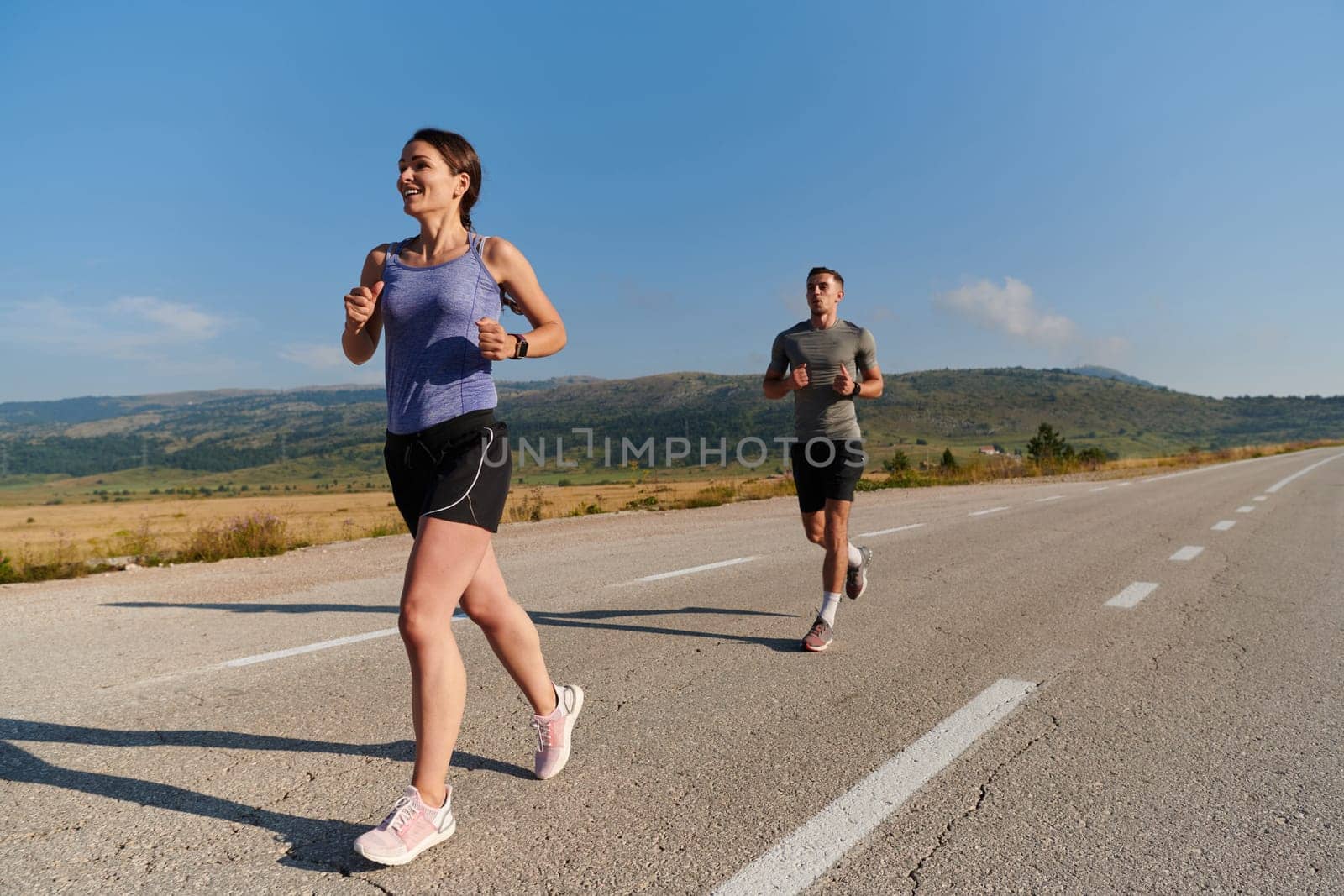 Energized by the beauty of nature, a couple powers through their morning run, their bodies and spirits invigorated. by dotshock