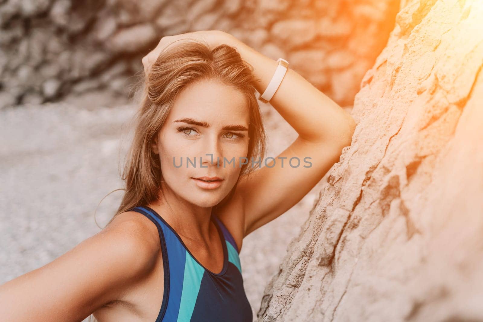 Woman travel sea. Young Happy woman in a long red dress posing on a beach near the sea on background of volcanic rocks, like in Iceland, sharing travel adventure journey