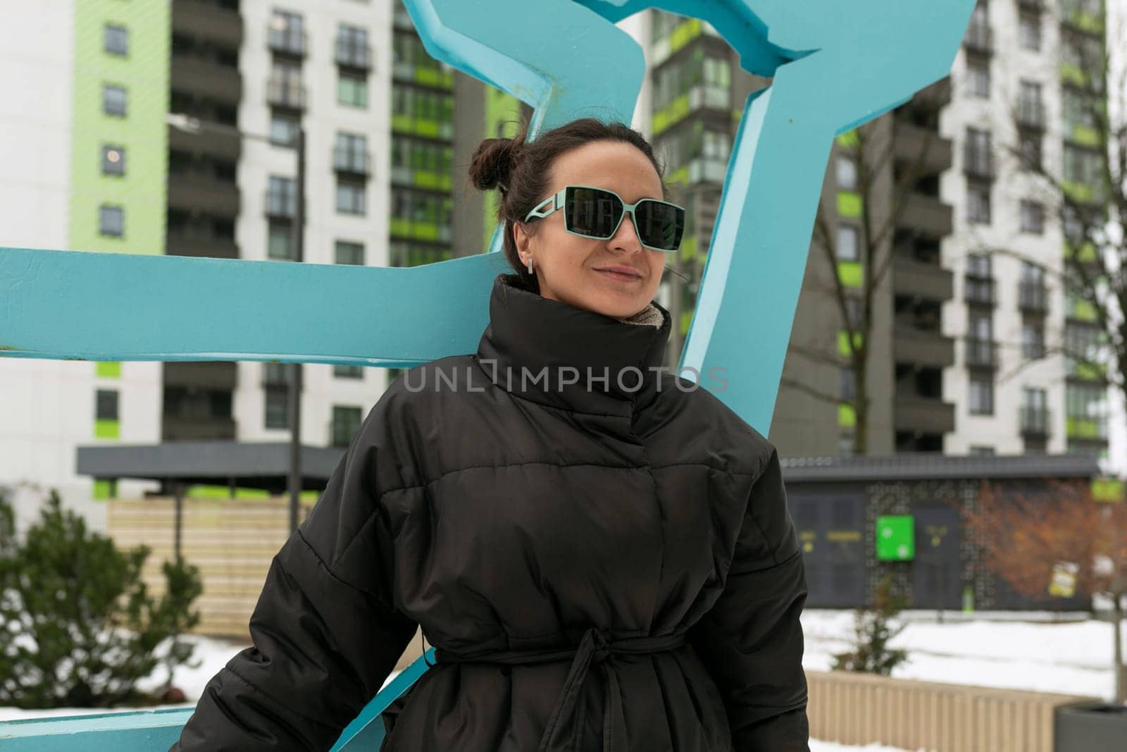 Weekend concept, brunette woman in a stylish black jacket walking in the cold.