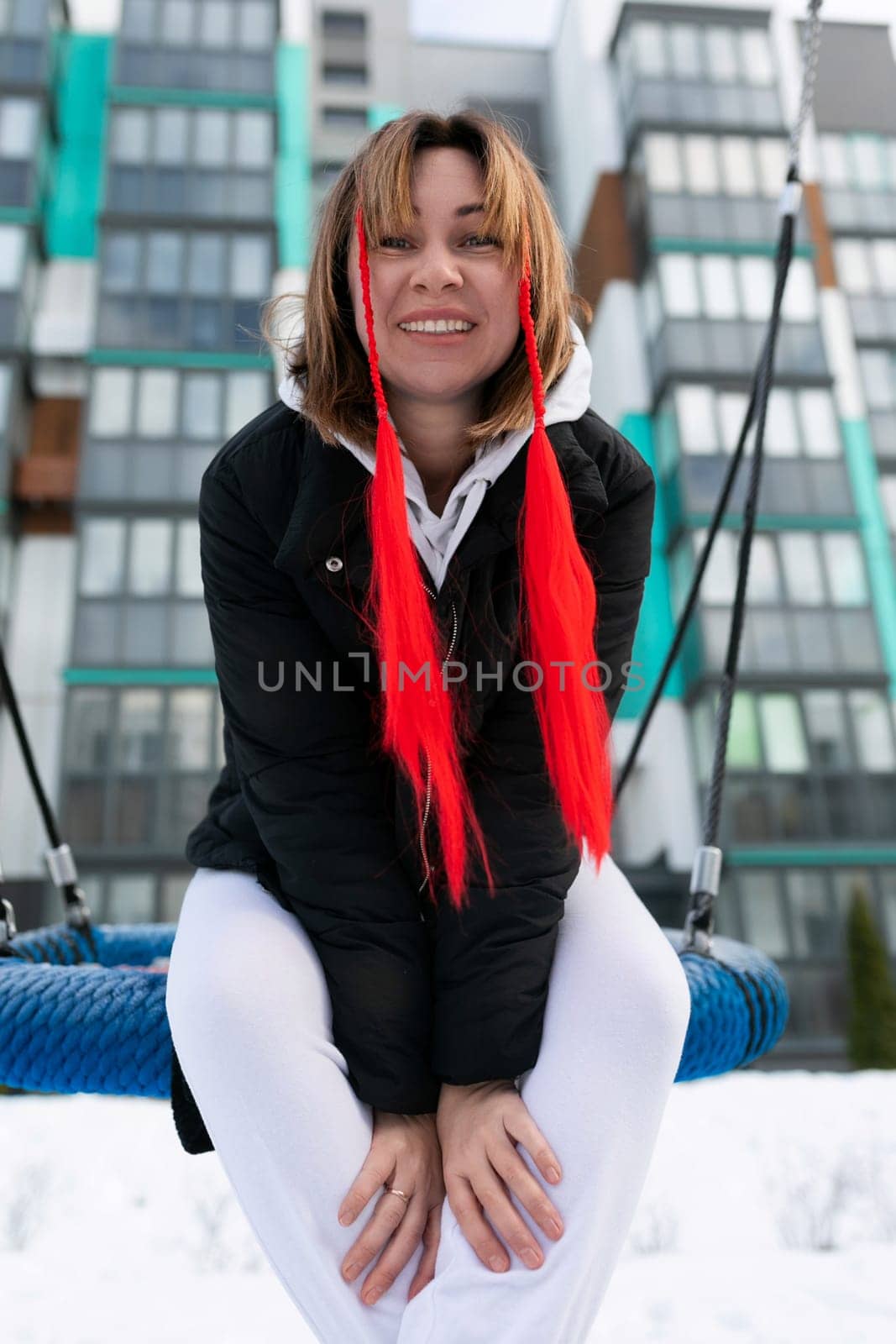 European woman having fun and fooling around outdoors in winter by TRMK