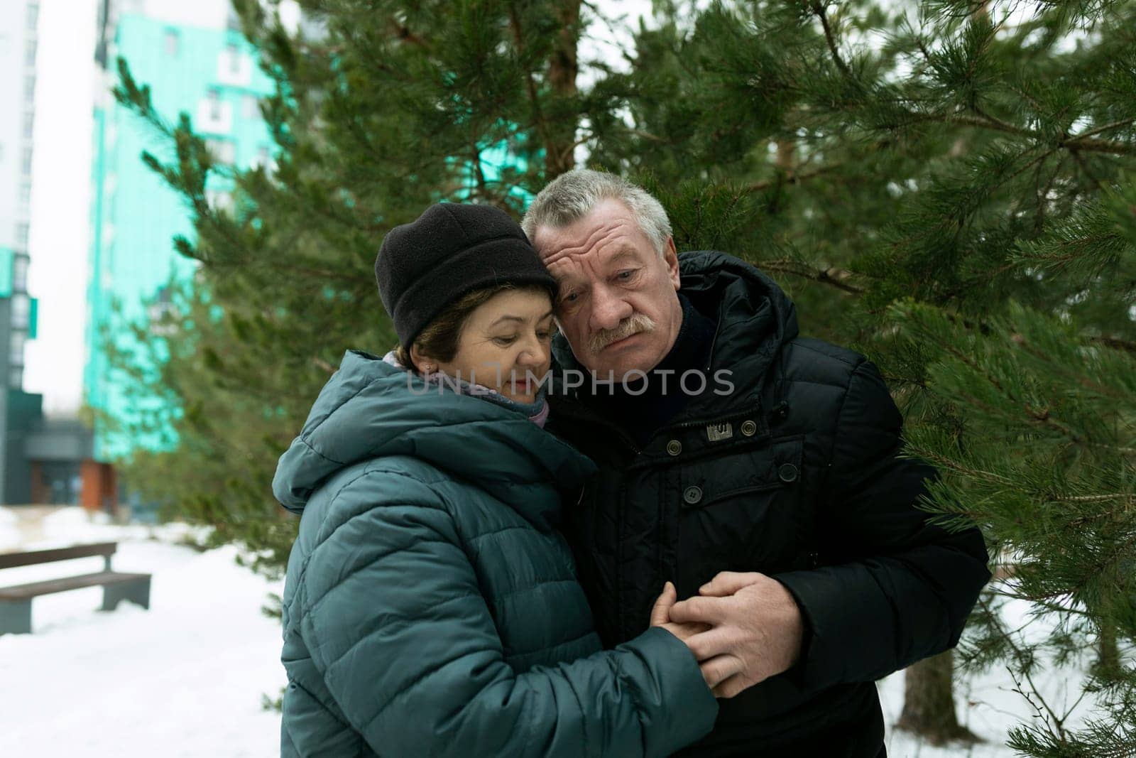 European mature family hugging each other while walking by TRMK