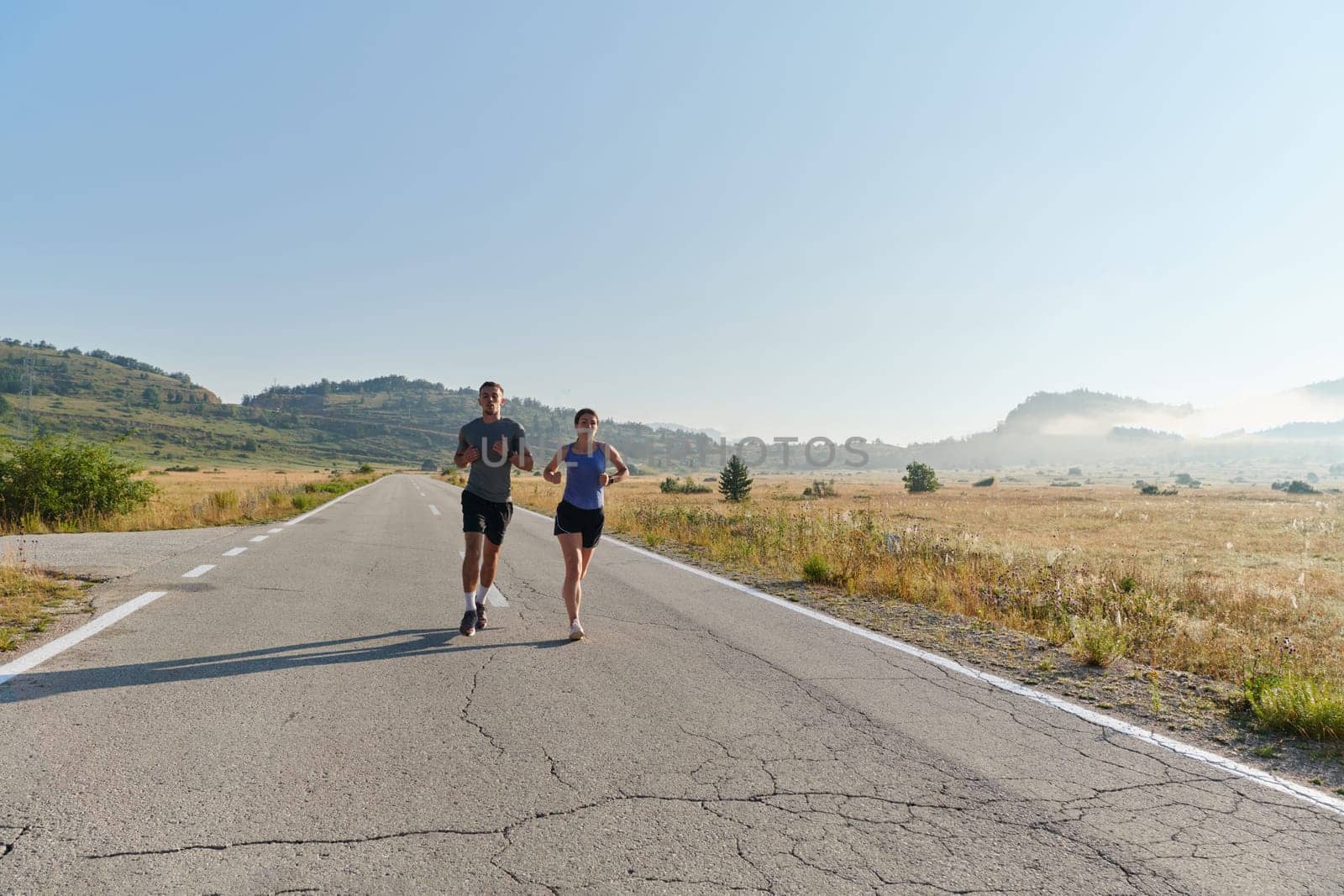 Energized by the beauty of nature, a couple powers through their morning run, their bodies and spirits invigorated. by dotshock