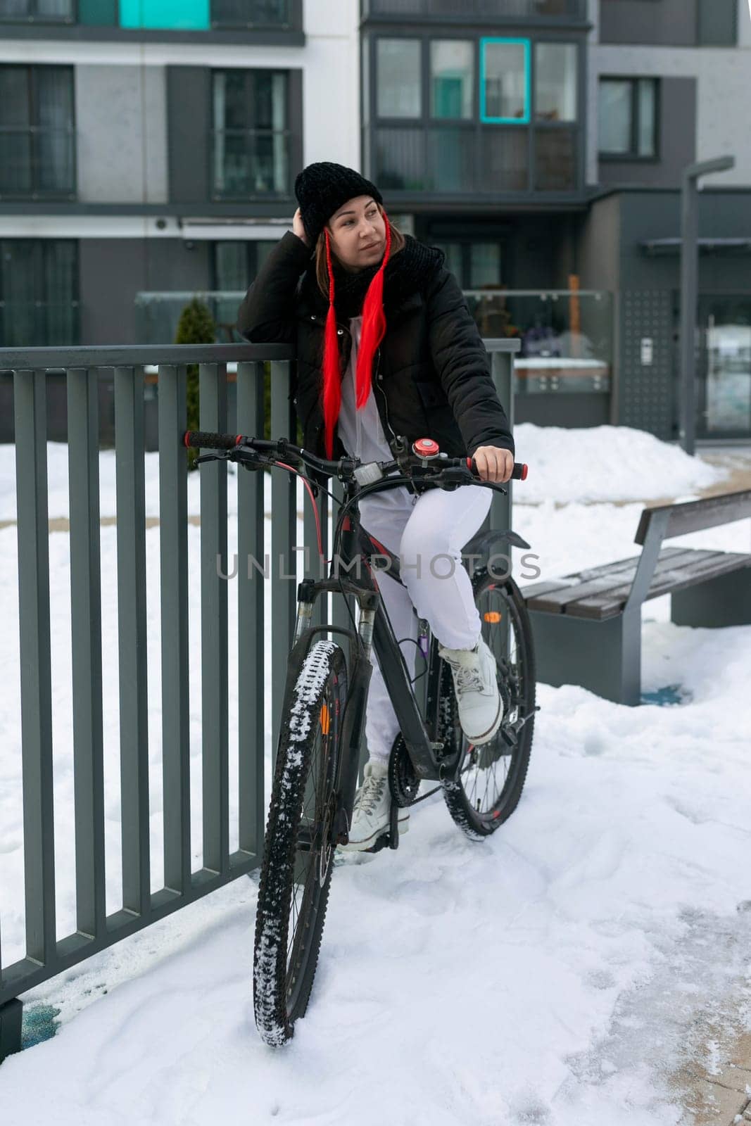 A woman rented a bicycle to ride around the city in winter. by TRMK