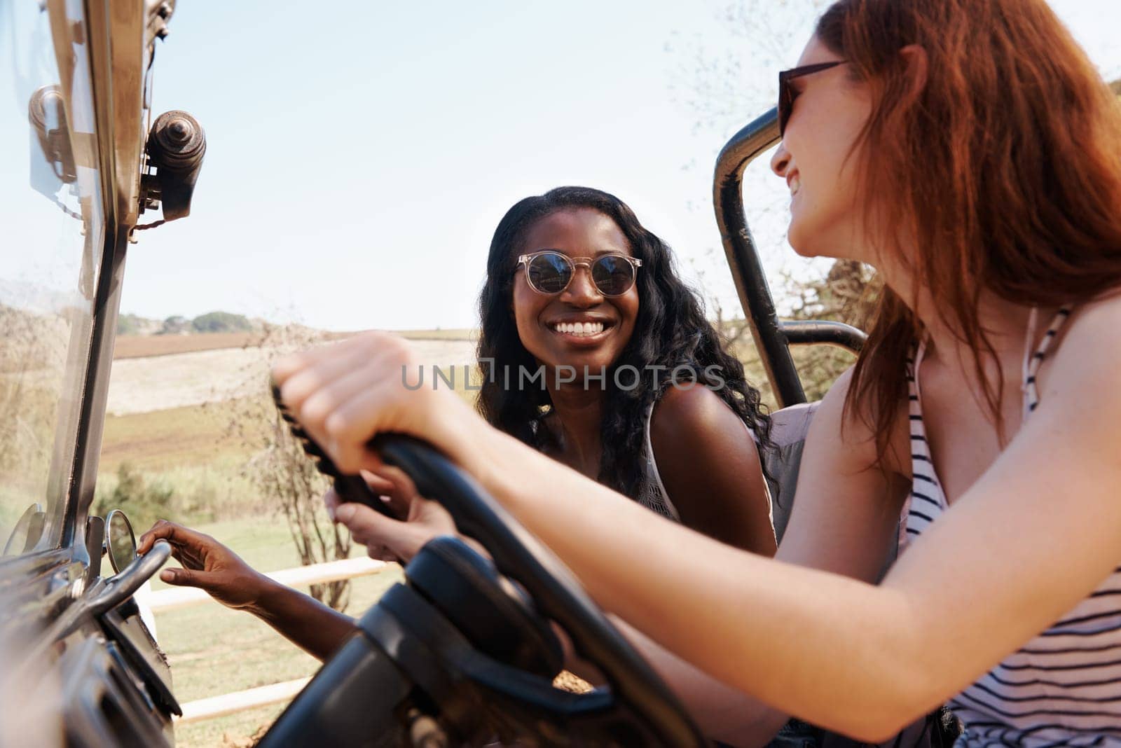 Happy women, bonding and travel on road trip in countryside and sightseeing for adventure in nature. Friends, driving and transportation in offroad vehicle on holiday outdoor in summer in california.