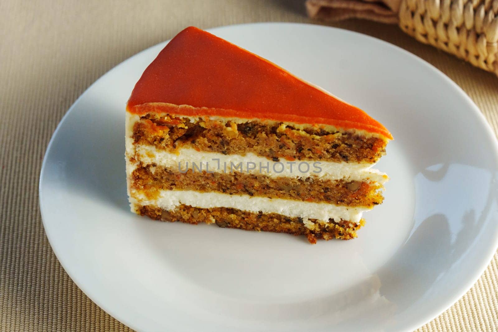 Featuring a slice of moist and flavorful carrot cake beautifully presented on a pristine white plate.