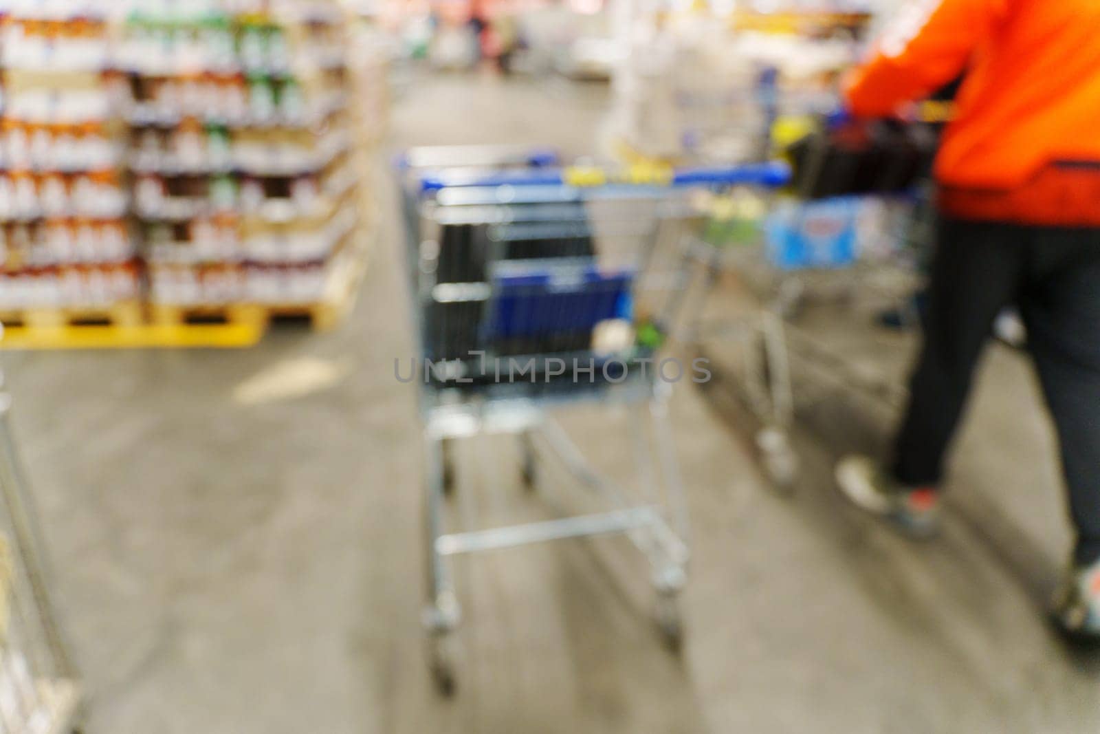 Blurry Shopping Cart in Store, selective focus. Shopping at the hypermarket