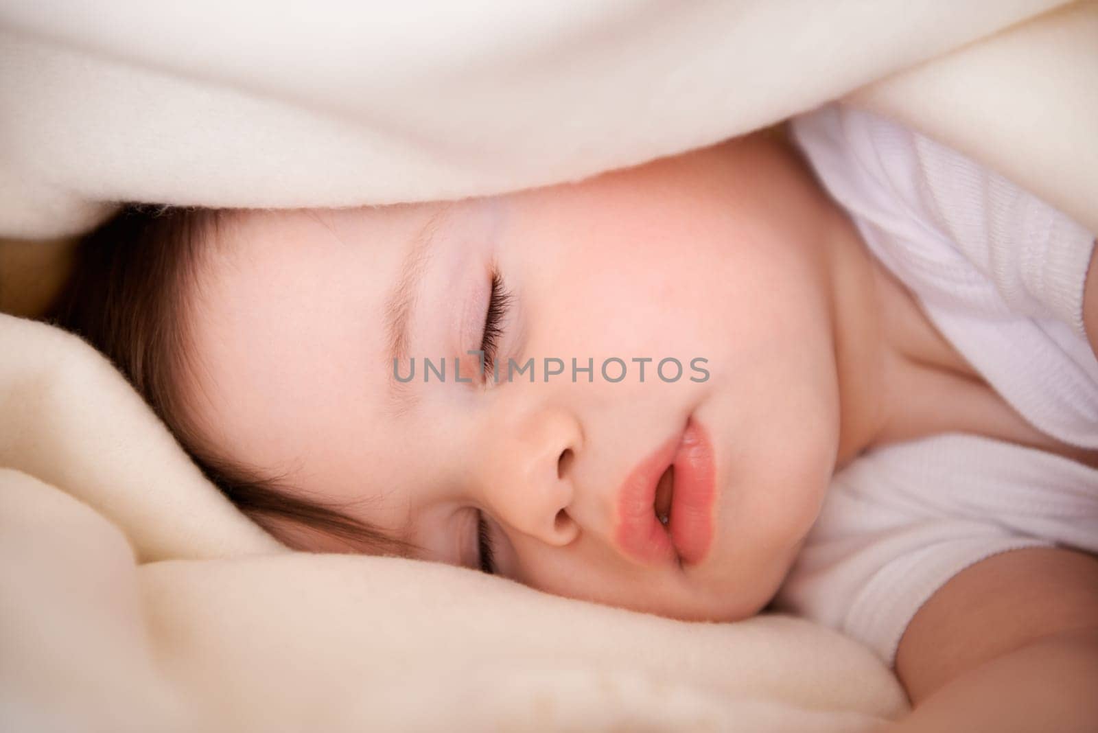 Baby, sleeping and home with relax, nap and nursery with peace in a bed with blanket. Morning, youth and kid with dream of an infant with child development from rest in a bedroom with a newborn by YuriArcurs