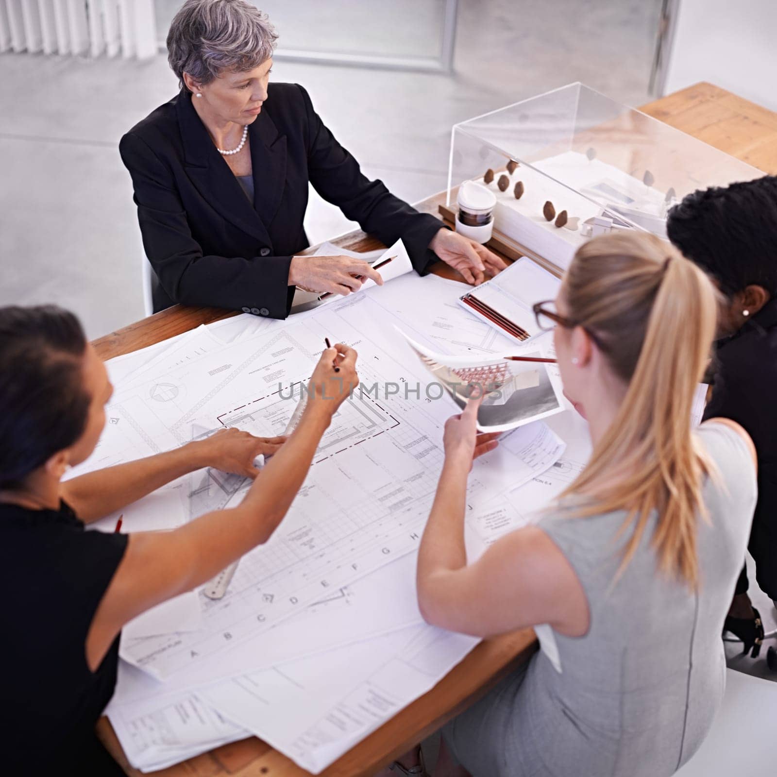 Architecture, blueprint or civil engineering team drawing for development project and planning on paper. Women, people or group of designers with ideas for sketching floor plan of office building.