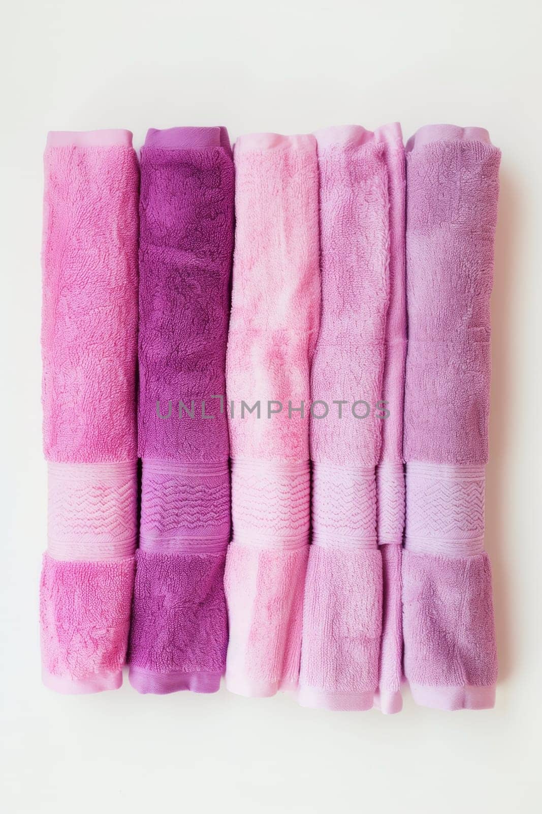 Clean pink and purple towels on a white insulated background by Lobachad