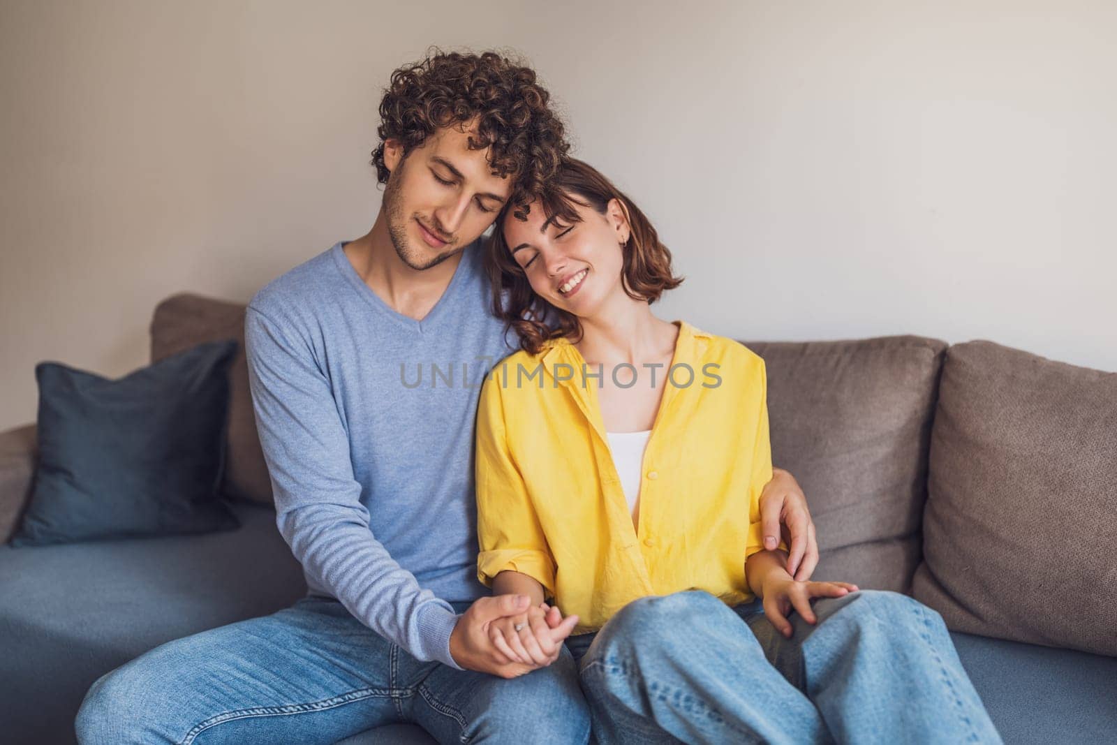 Young couple is relaxing and embracing at their home.