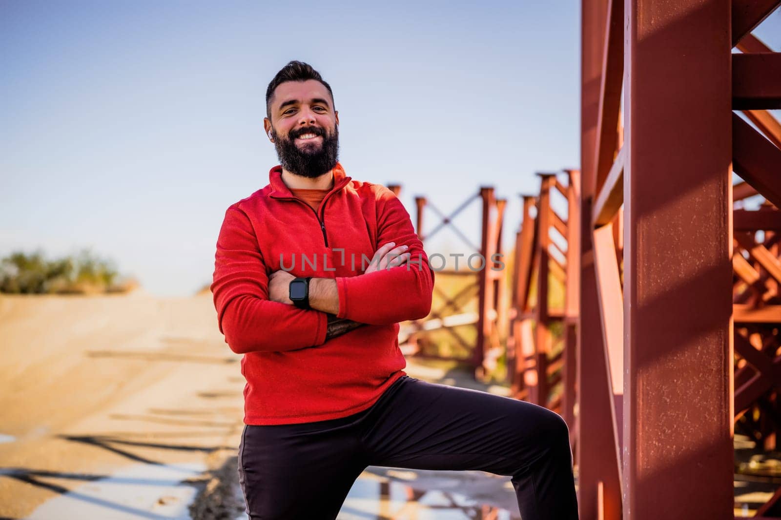 Adult man is ready for exercising outdoor on sunny day.