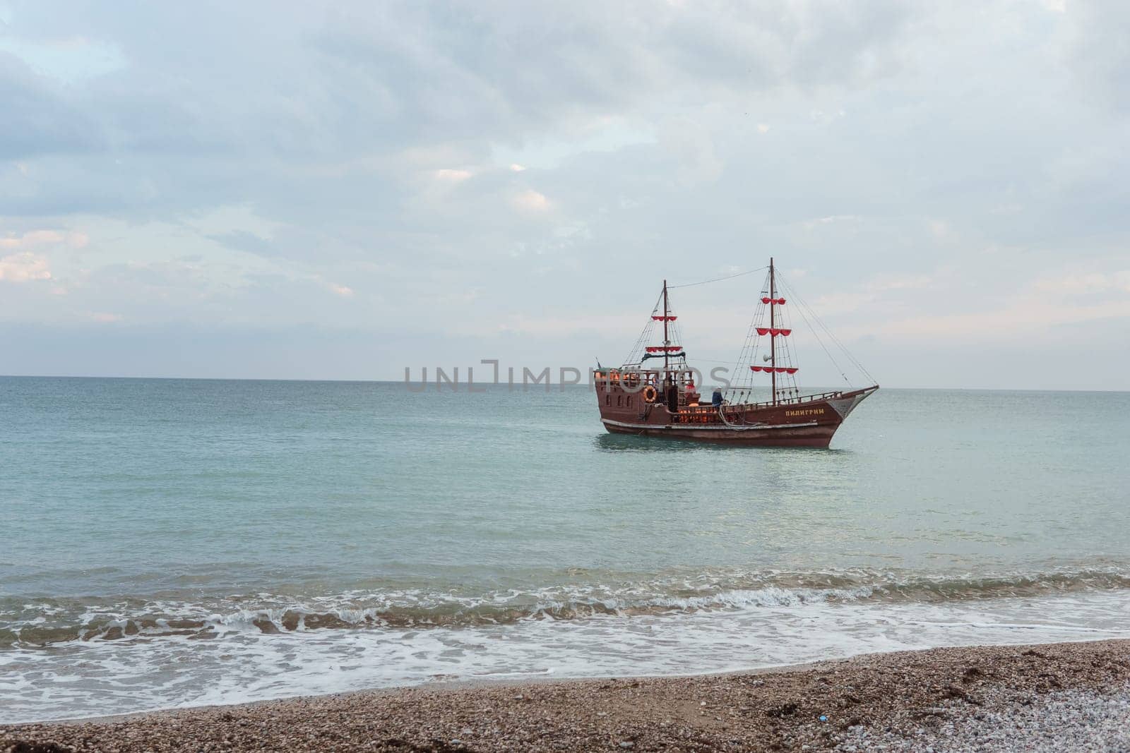 Sailing ship sailing to the shore, marine tourism. Beach holidays on the Black Sea. Fabulous moments of a sunny day. by Annu1tochka