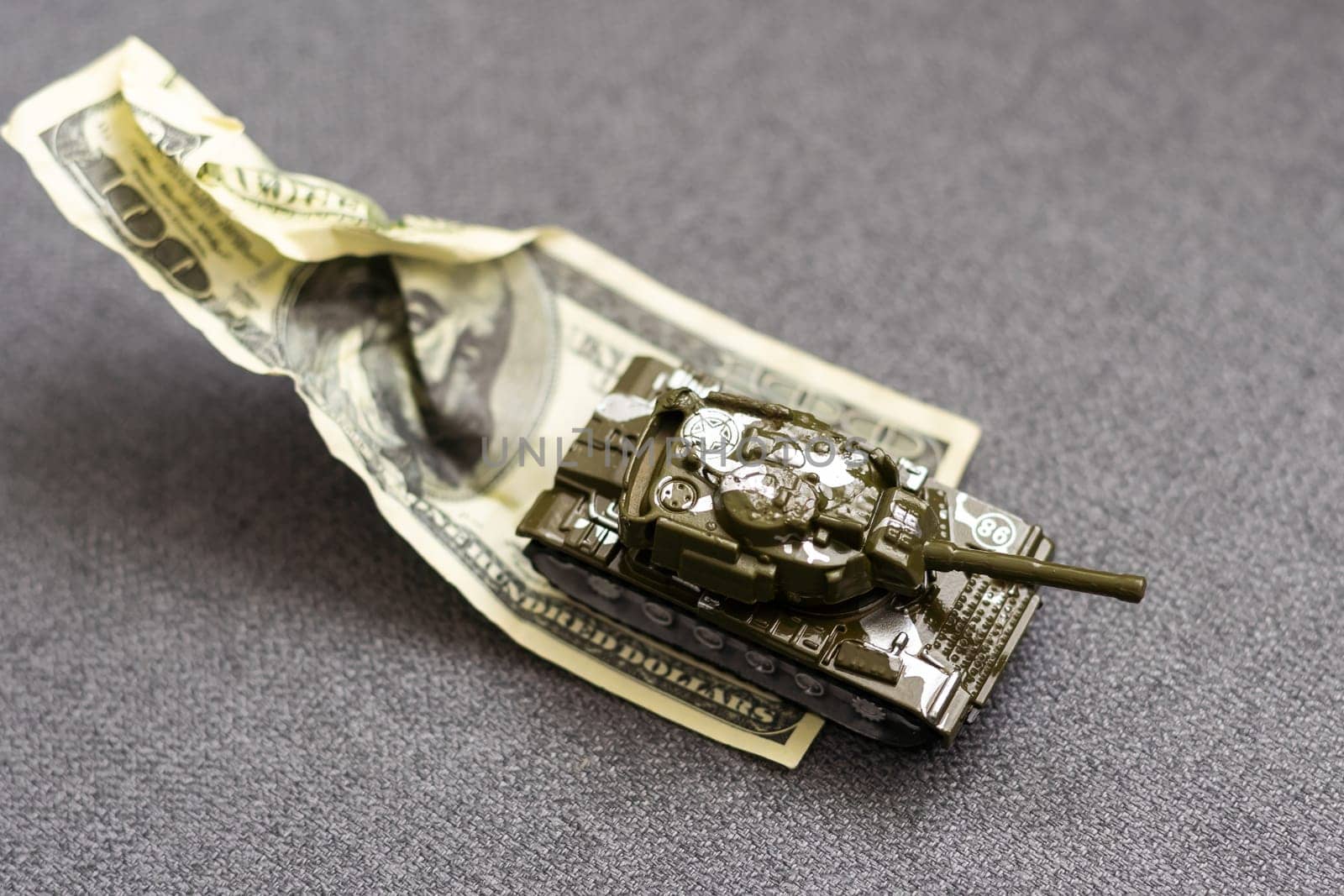 Tank on dollar banknotes. The concept of war costs, military spending, economic crisis. High quality photo