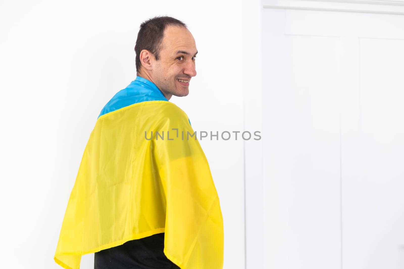 Portrait of a middle aged man with flag of Ukraine. High quality photo