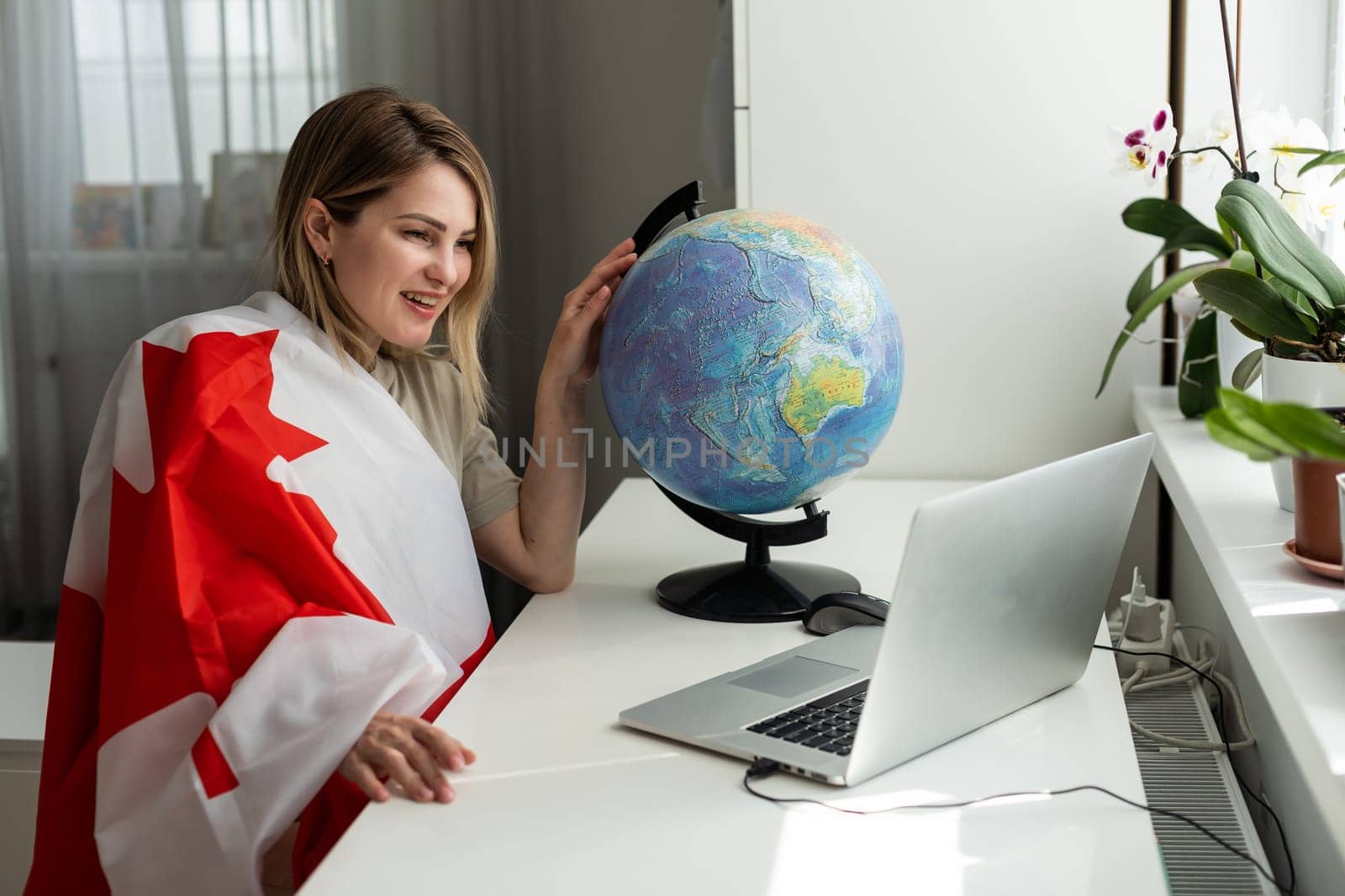 Young female student with Canadian flag and laptop with space for text by Andelov13