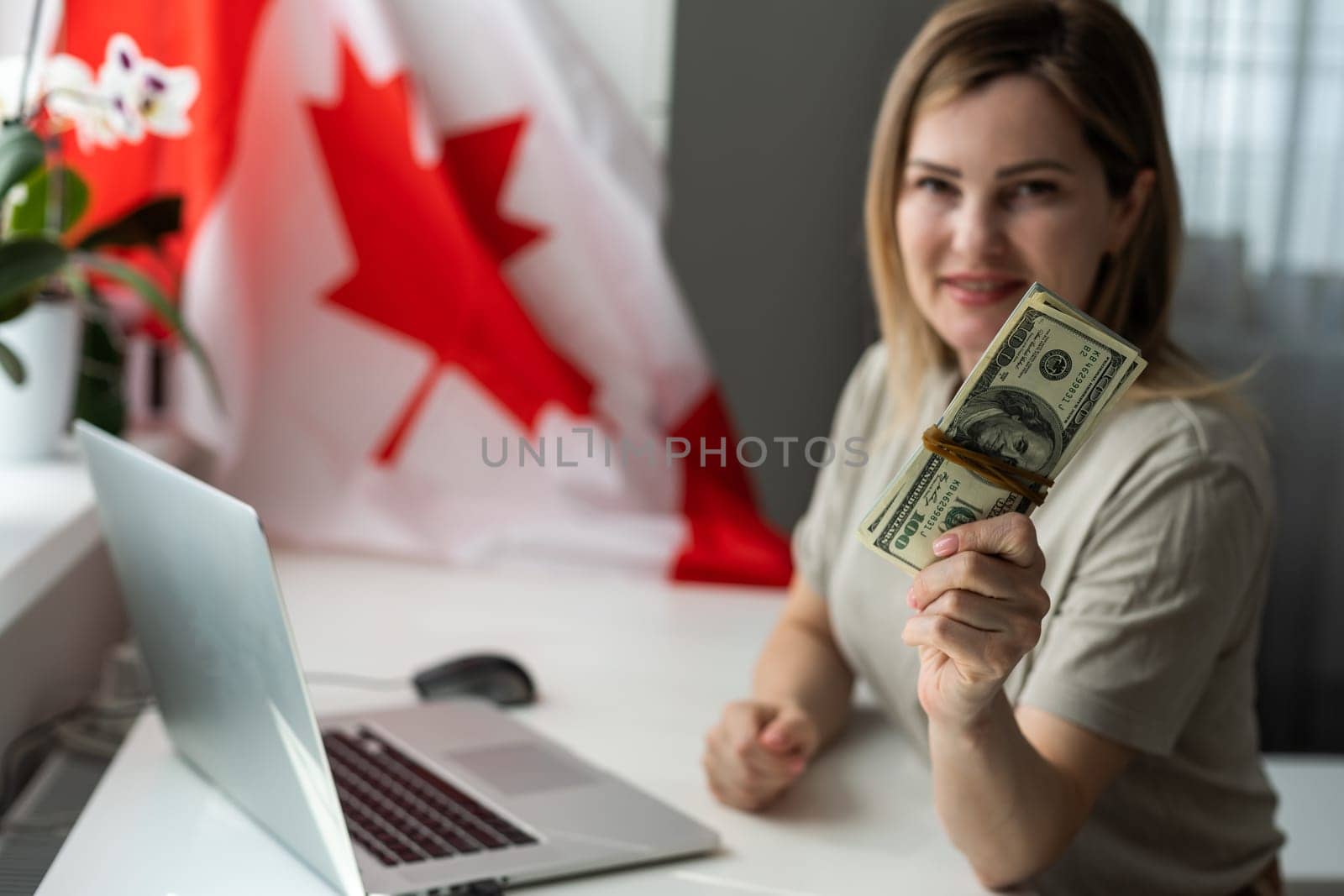 woman hands and flag of Canada on computer, laptop keyboard by Andelov13