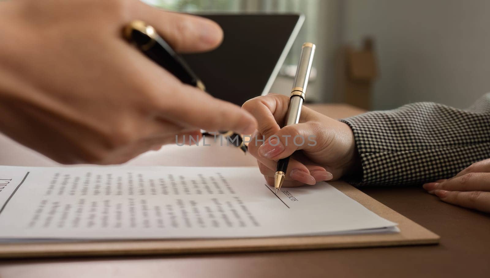 Lawyer and businesswomen discussing and introducing Providing legal advice regarding signing insurance contracts or financial contracts by wichayada