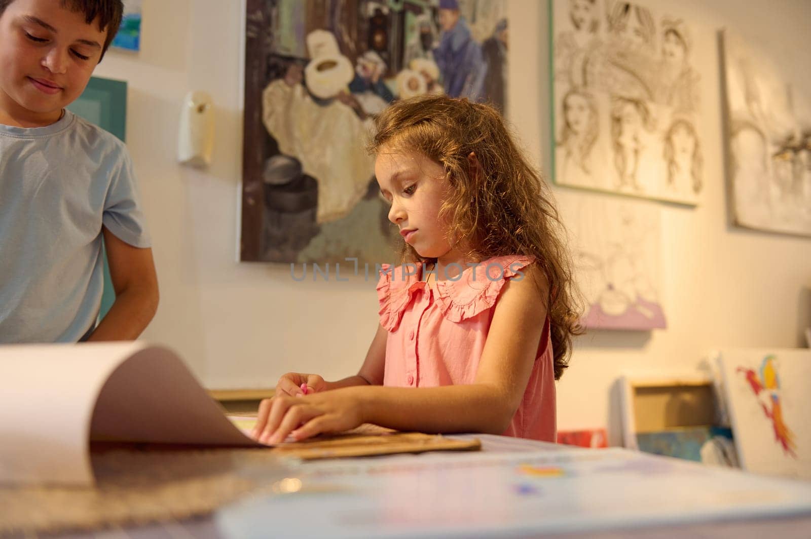 Portrait of an Caucasian authentic schoolgirl learning painting in the art class in visual art gallery or creative art school