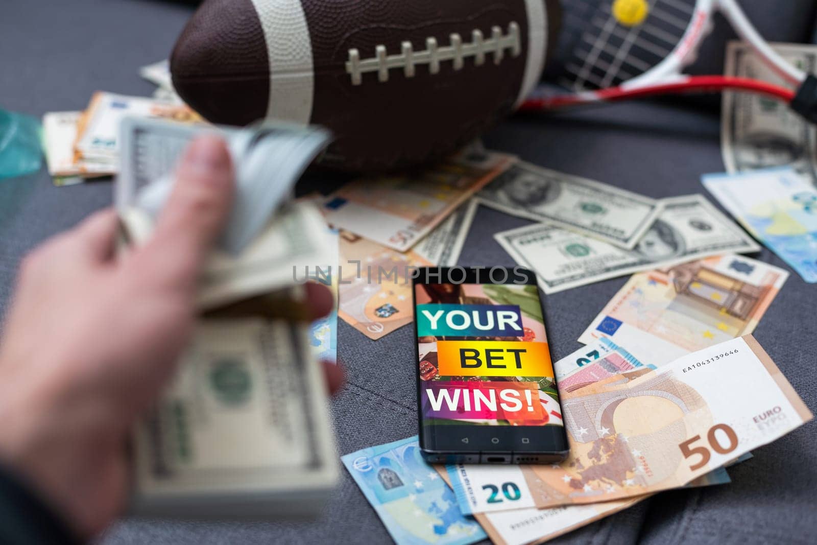 Smartphone with gambling mobile application, ball and money banknotes. Sport and betting concept by Andelov13