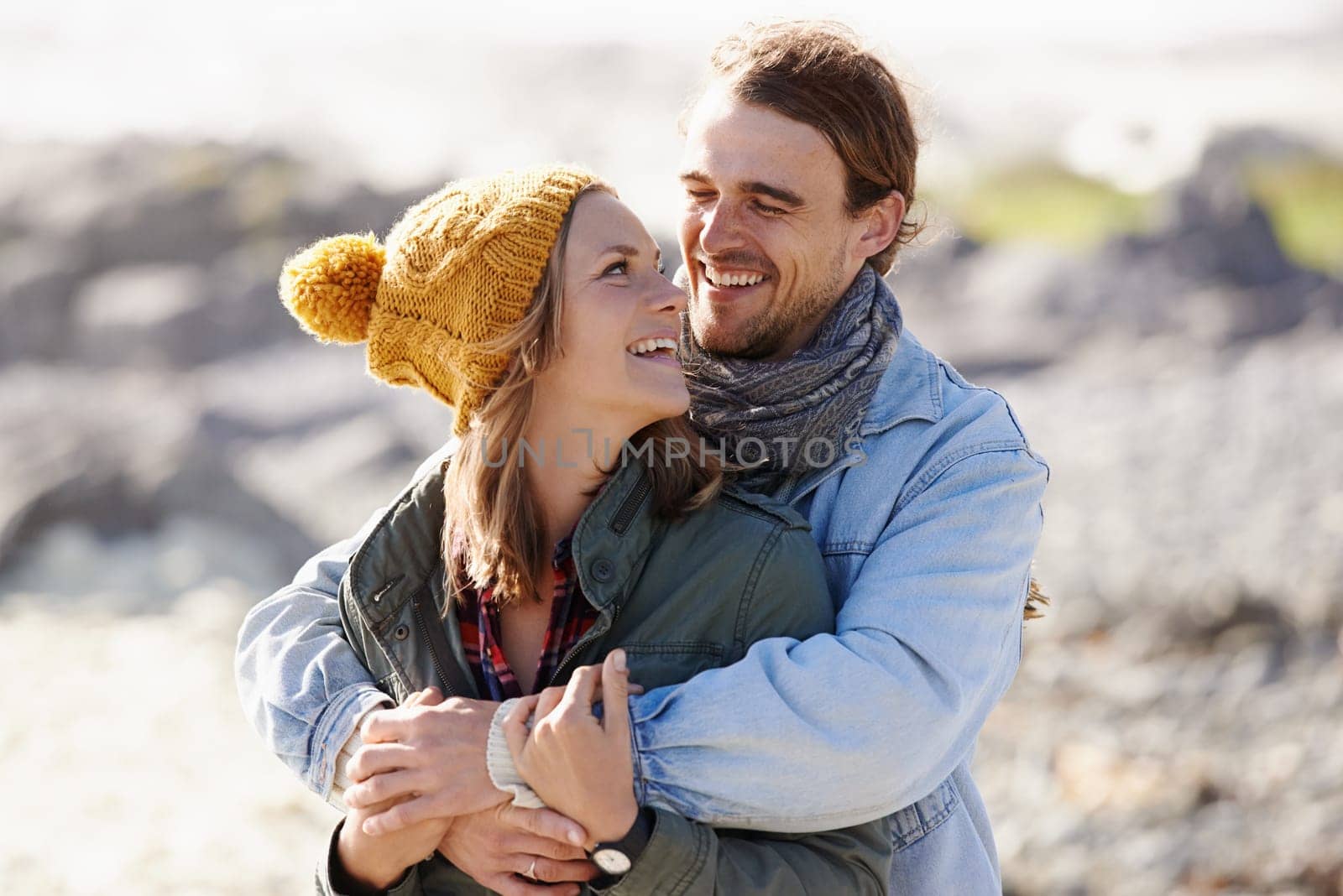 Hug, nature and couple with love, smile and happiness with weekend break and vacation for honeymoon. Outdoor, romance and embrace with woman and man with sunshine and summer with holiday and romance.