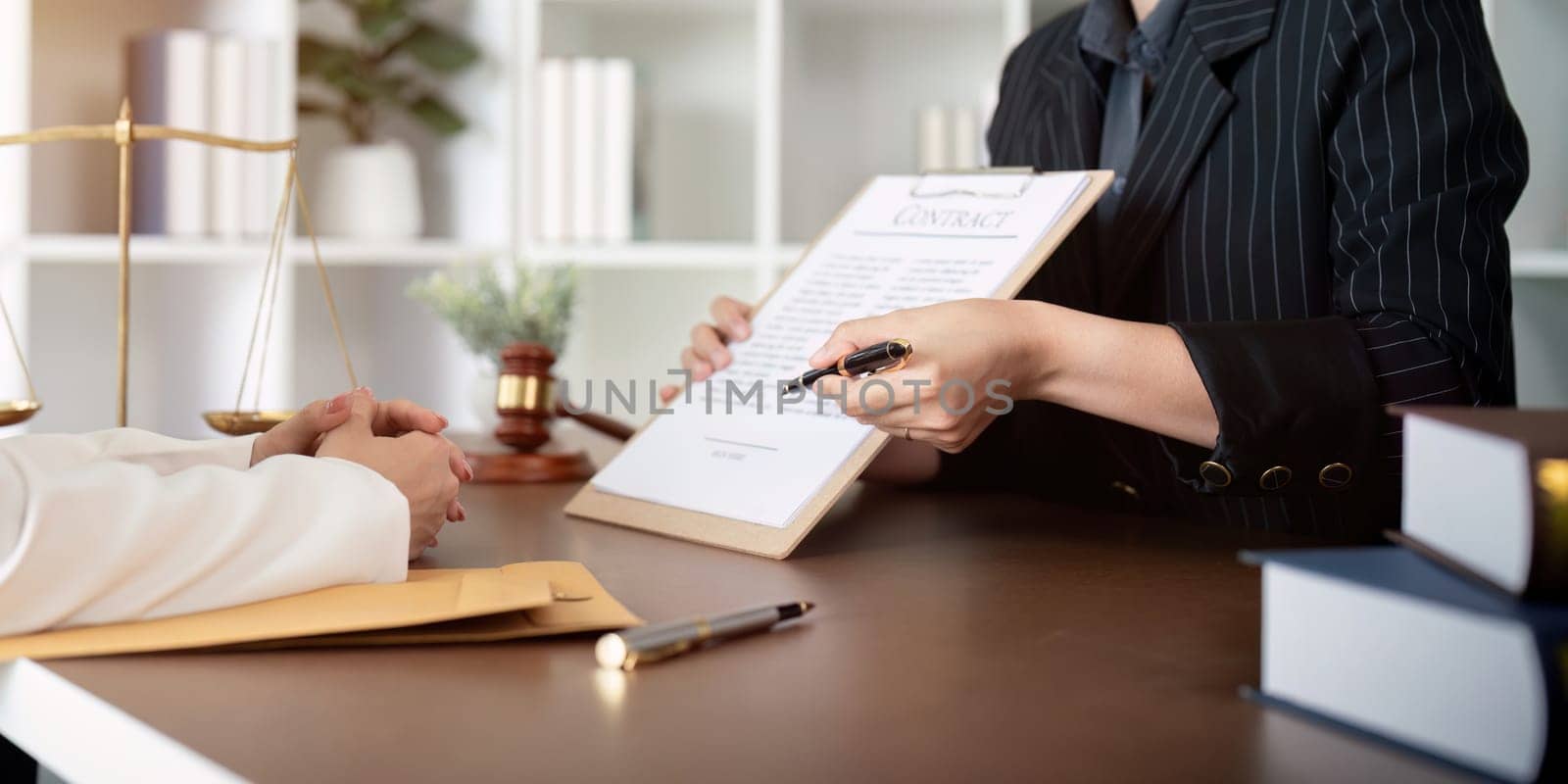 Lawyer office the company hired the lawyer office a legal advisor and draft the contract so that the client could signs contract. Contract of sale was on the table in the lawyer office by nateemee