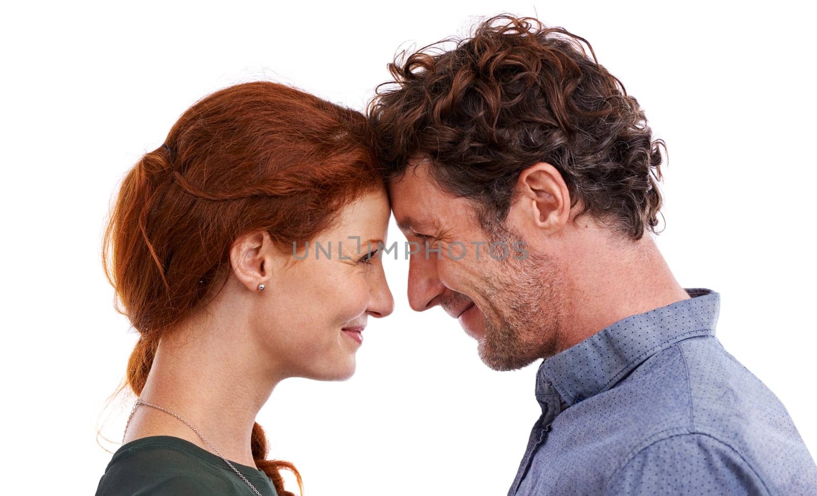 Couple, forehead touch and love in studio, romance and smile for relationship on white background. Happy people, commitment and trust in security of marriage, bonding and affection for anniversary.