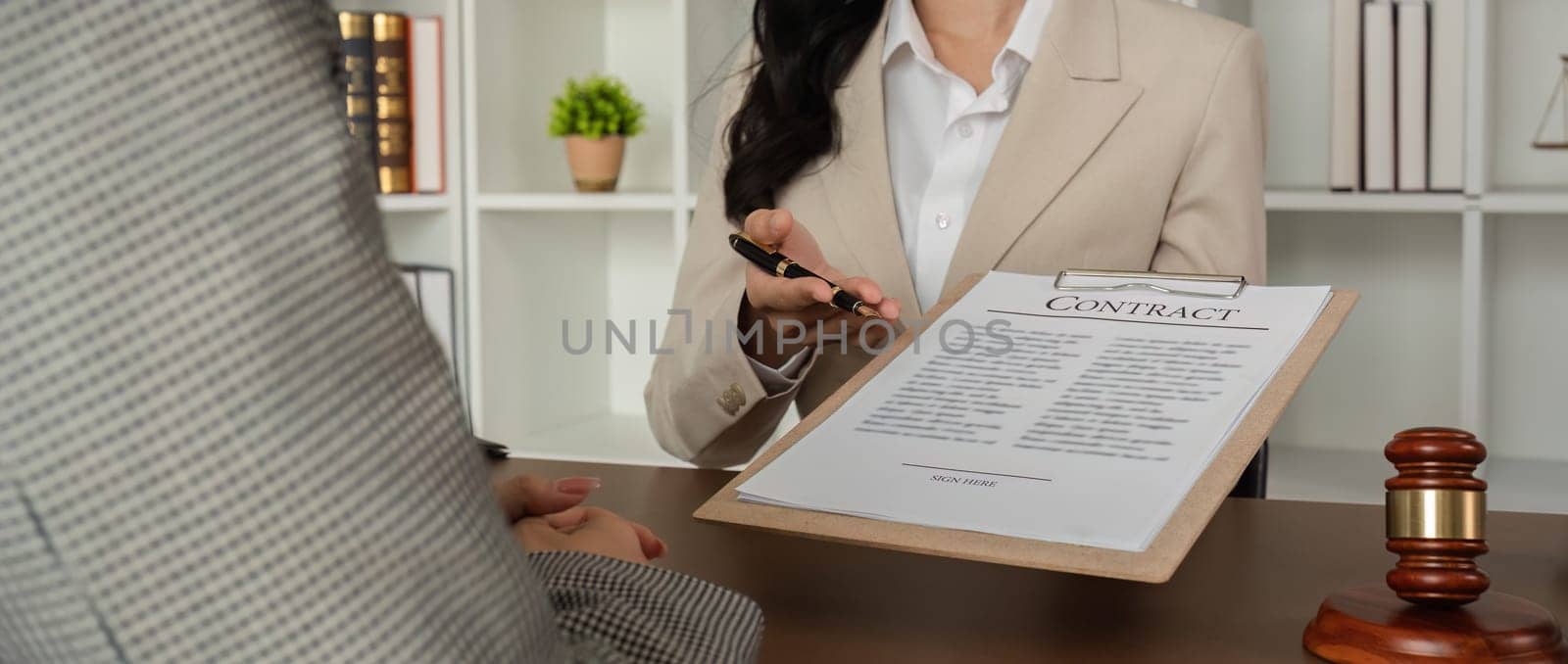 close up, Lawyer and businesswomen discussing and introducing Providing legal advice regarding signing insurance contracts or financial contracts by wichayada