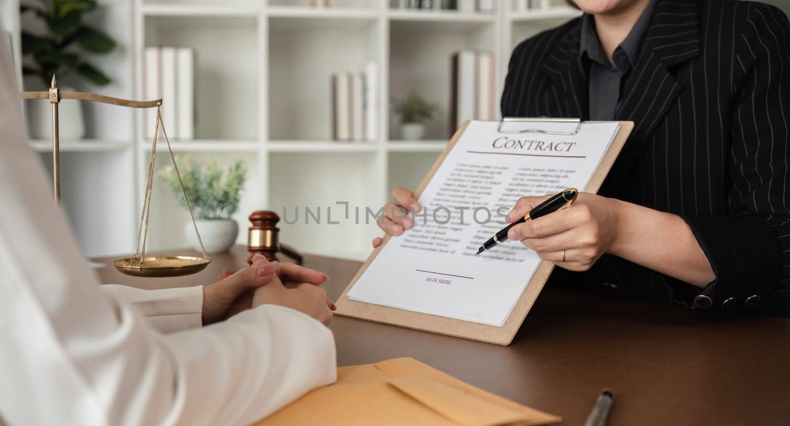 close up, Lawyer and businesswomen discussing and introducing Providing legal advice regarding signing insurance contracts or financial contracts by wichayada