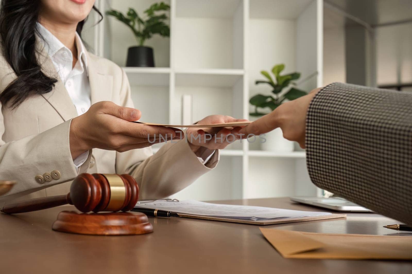 A young lawyer and businesswoman are discussing legal advice on signing a business contract. Insurance or financial contract signing by wichayada