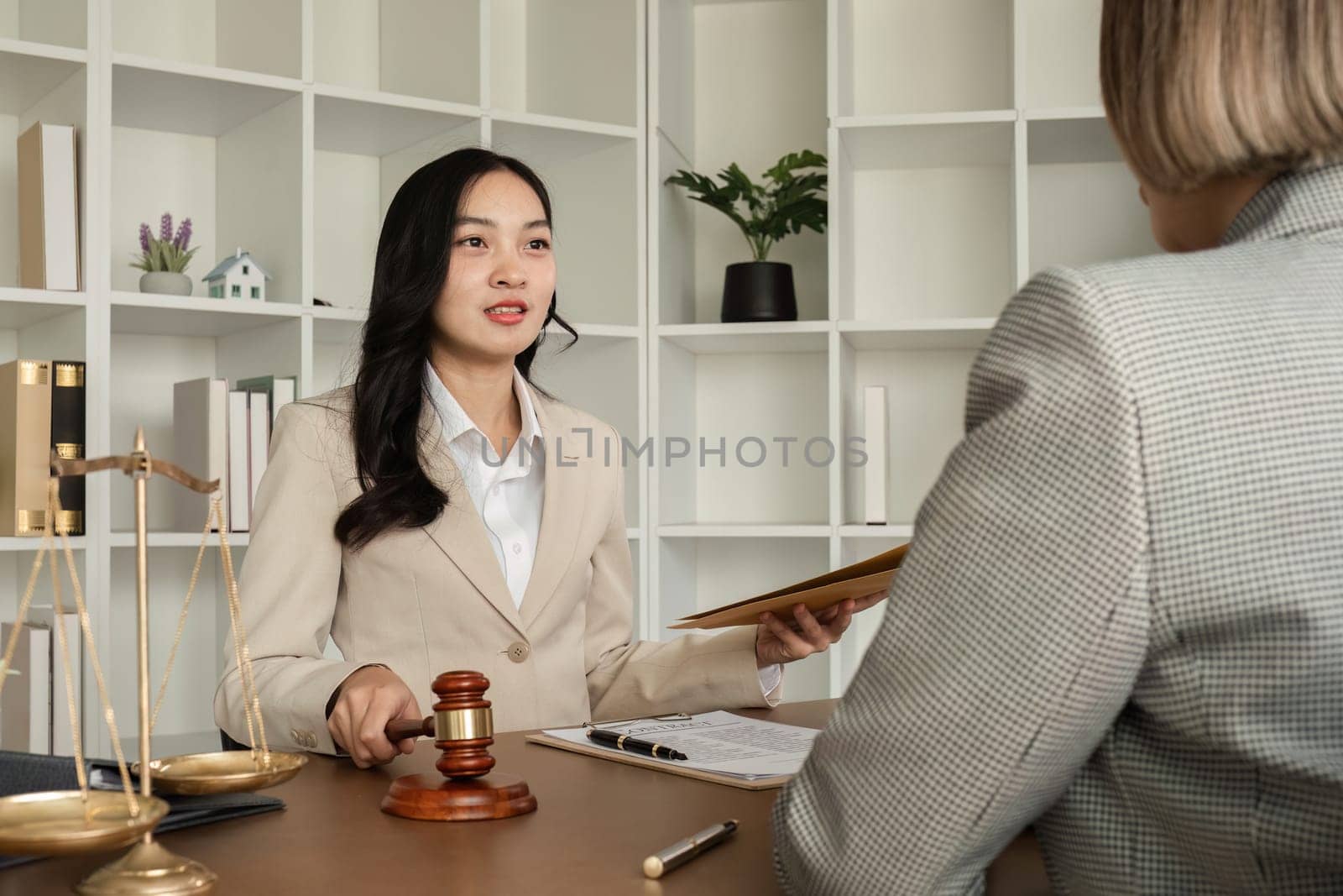 A young lawyer and businesswoman are discussing legal advice on signing a business contract. Insurance or financial contract signing.