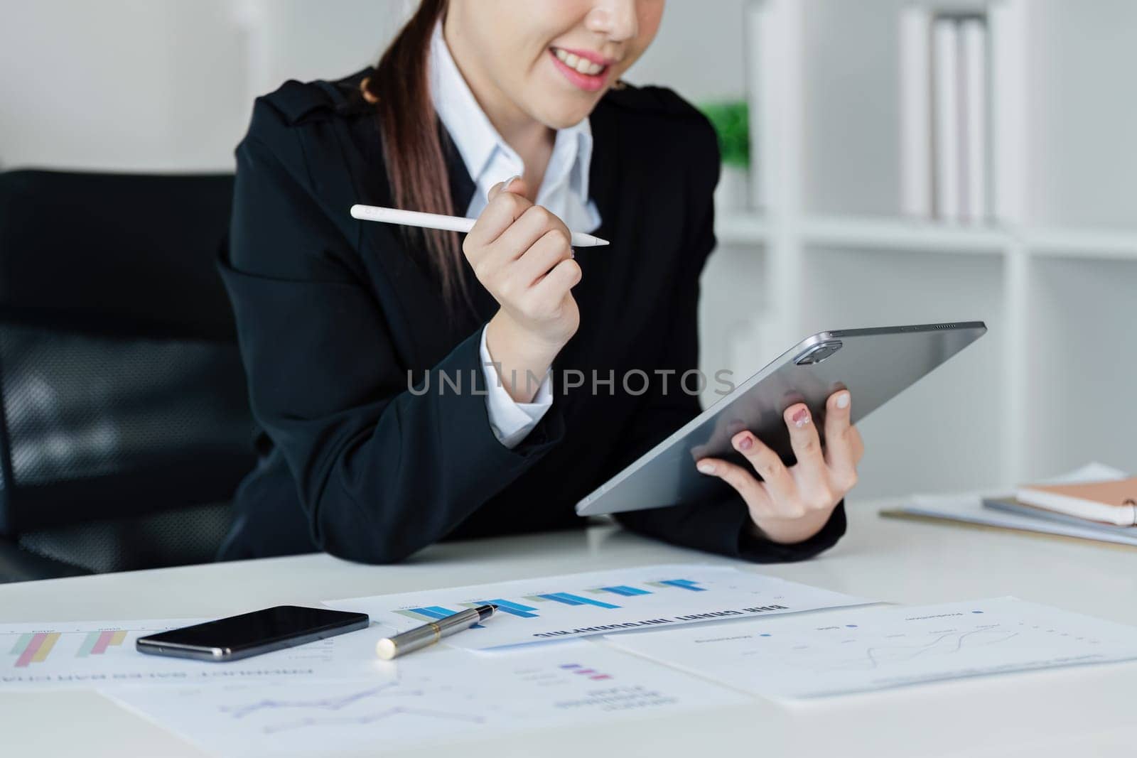 Accountant business woman working with tablet to think strategy and analyze by itchaznong