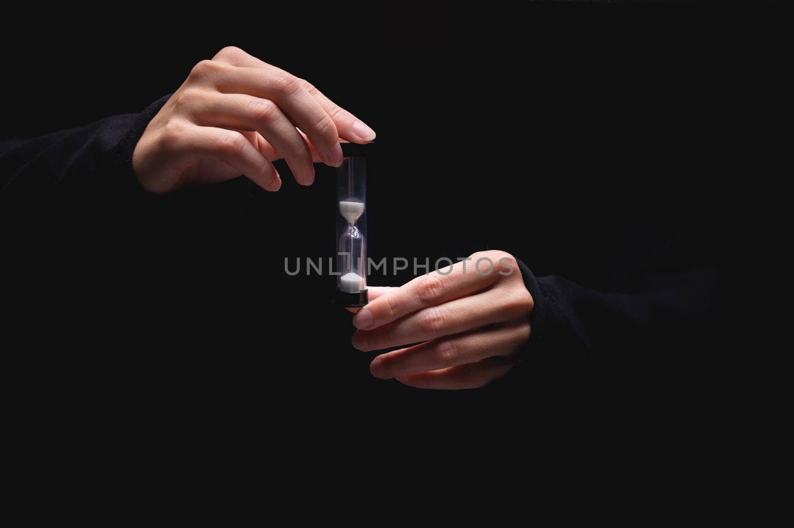 concept image of person holding hourglass. deadline and schedule concept.