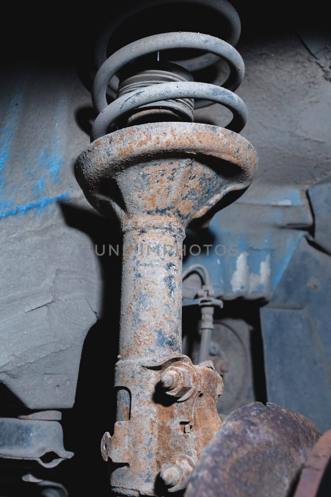 Rust protection and repair of a disk broken in a service center, close-up. Front suspension of an old car.
