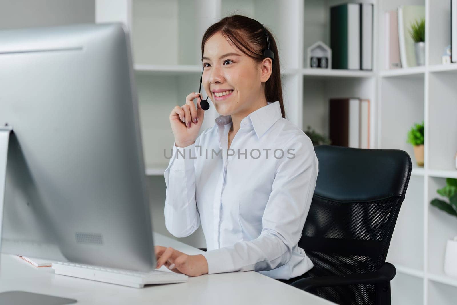 Customer service, woman and happy call center agent giving advice online using a headset by itchaznong