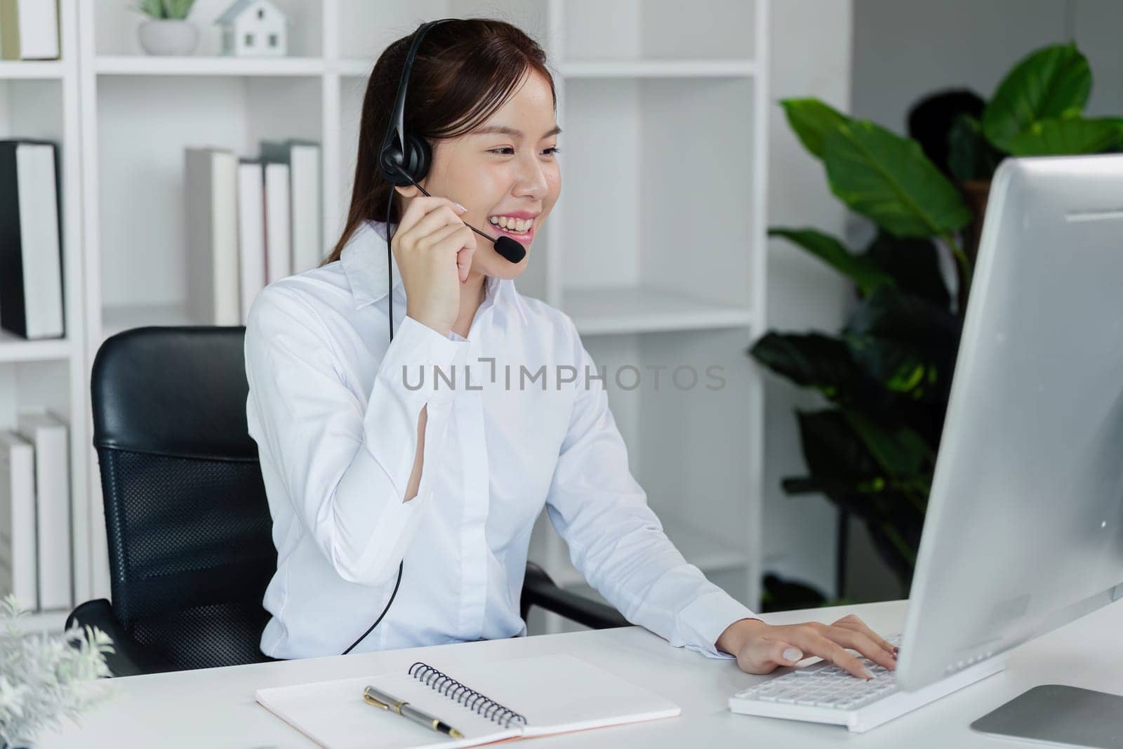 Customer service, woman and happy call center agent giving advice online using a headset by itchaznong